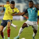Ecuador's Pervis Estupinan, right, and Colombia's Daniel Munoz battle for the ball during a Copa America soccer match at Arena Pantanal stadium in Cuiaba, Brazil, Sunday, June 13, 2021. (AP Photo/Bruna Prado)