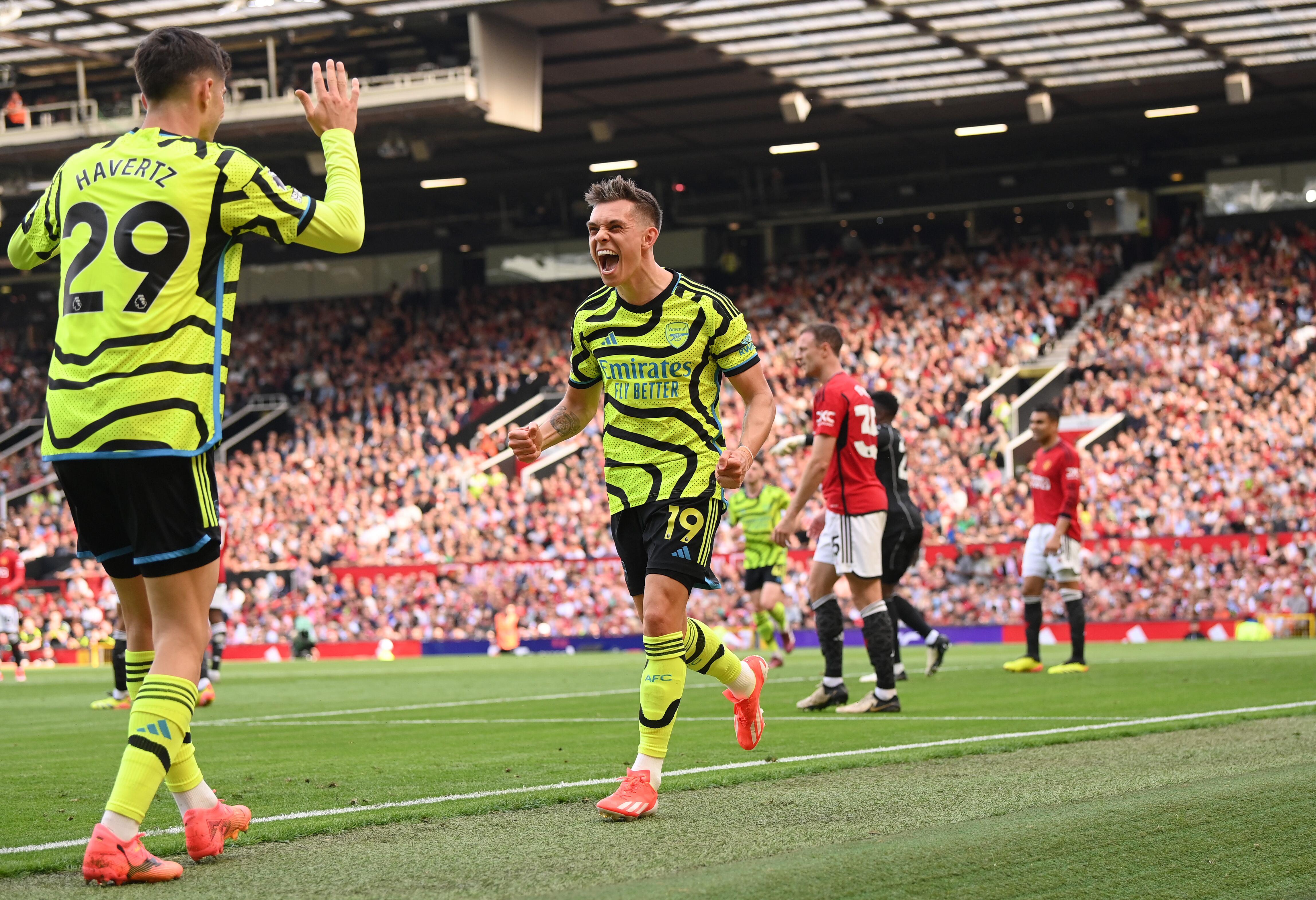 MANCHESTER, ENGLAND - MAY 12: Leandro Trossard of Arsenal celebrates scoring his team's first goal with teammate Kai Havertz during the Premier League match between Manchester United and Arsenal FC at Old Trafford on May 12, 2024 in Manchester, England. (Photo by Stu Forster/Getty Images)
