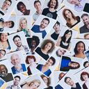 Mixture of multi-ethnic printed portraits scattered over a yellow background