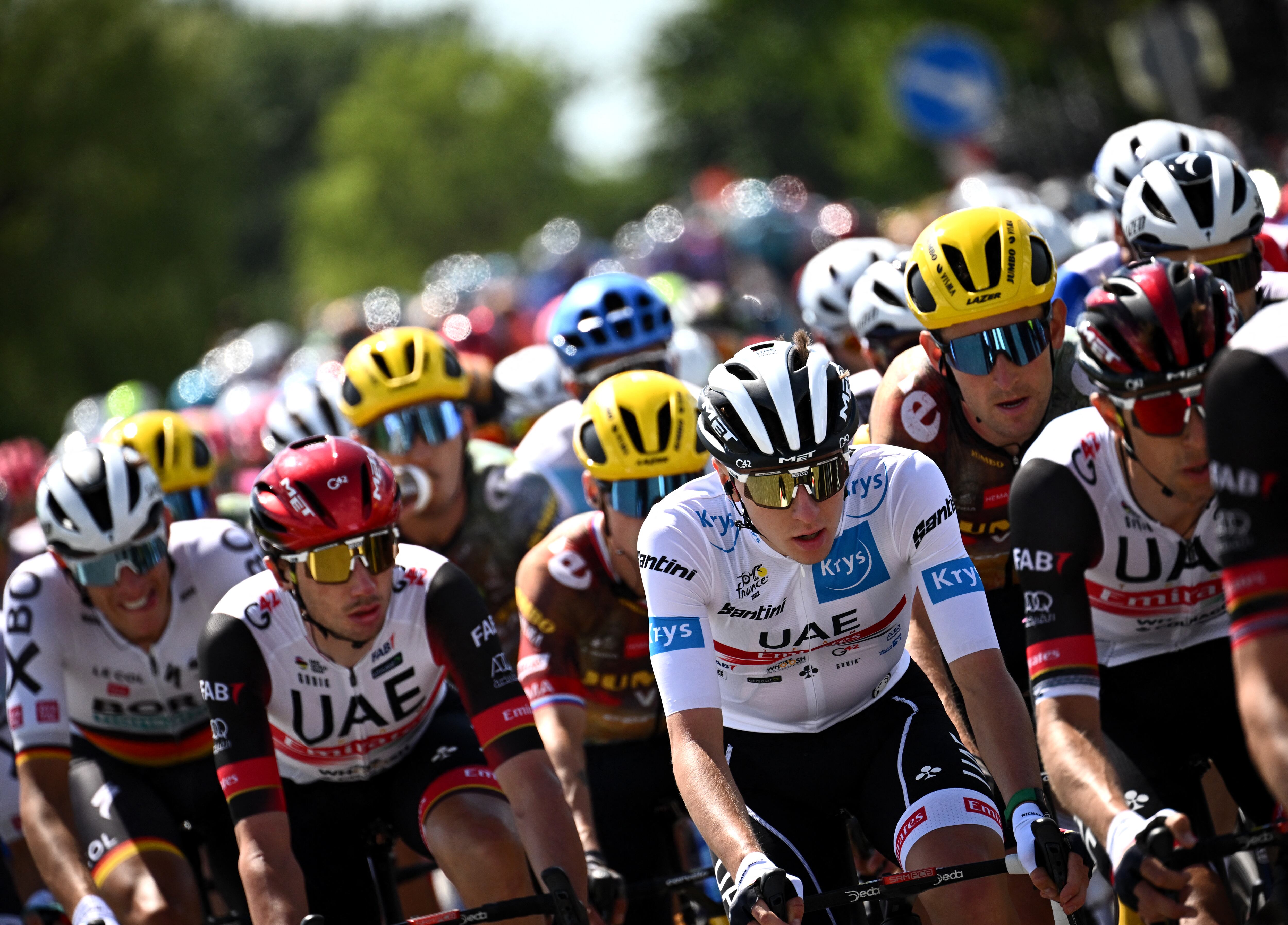 UAE Team Emirates team's Slovenian rider Tadej Pogacar wearing the best young rider's white jersey (C) cycles with the pack of riders during the 2nd stage of the 109th edition of the Tour de France cycling race, 202,2 km between Roskilde and Nyborg, in Denmark, on July 2, 2022. (Photo by Marco BERTORELLO / AFP)