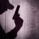 Gangster or investigator or spy silhouette on natural wooden wall. You can see more silhouettes and shadows on my page.