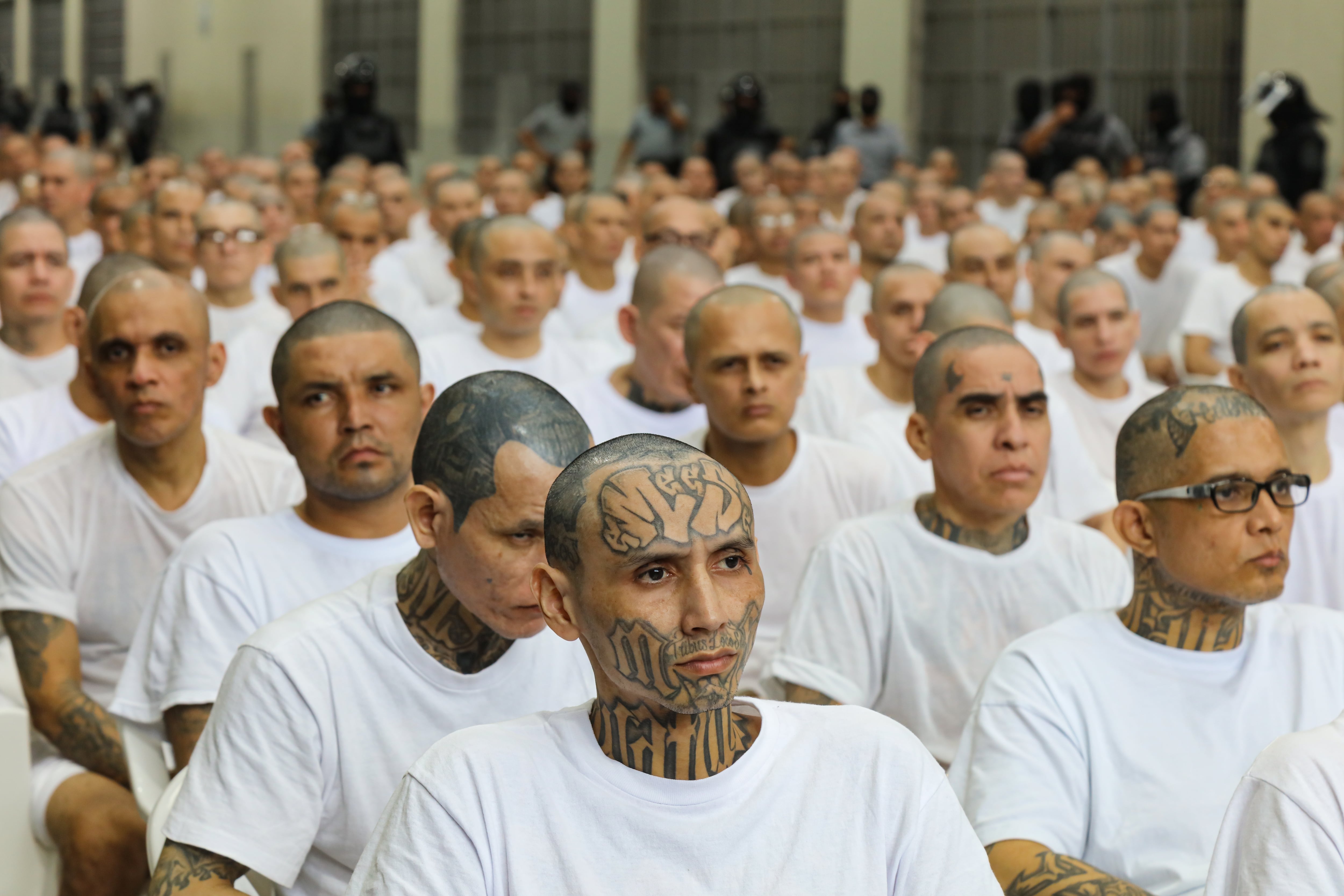 Reclusos escuchan durante una audiencia masiva contra delincuentes y miembros de pandillas en el CECOT, el 23 de abril de 2026, en Tecoluca, El Salvador.