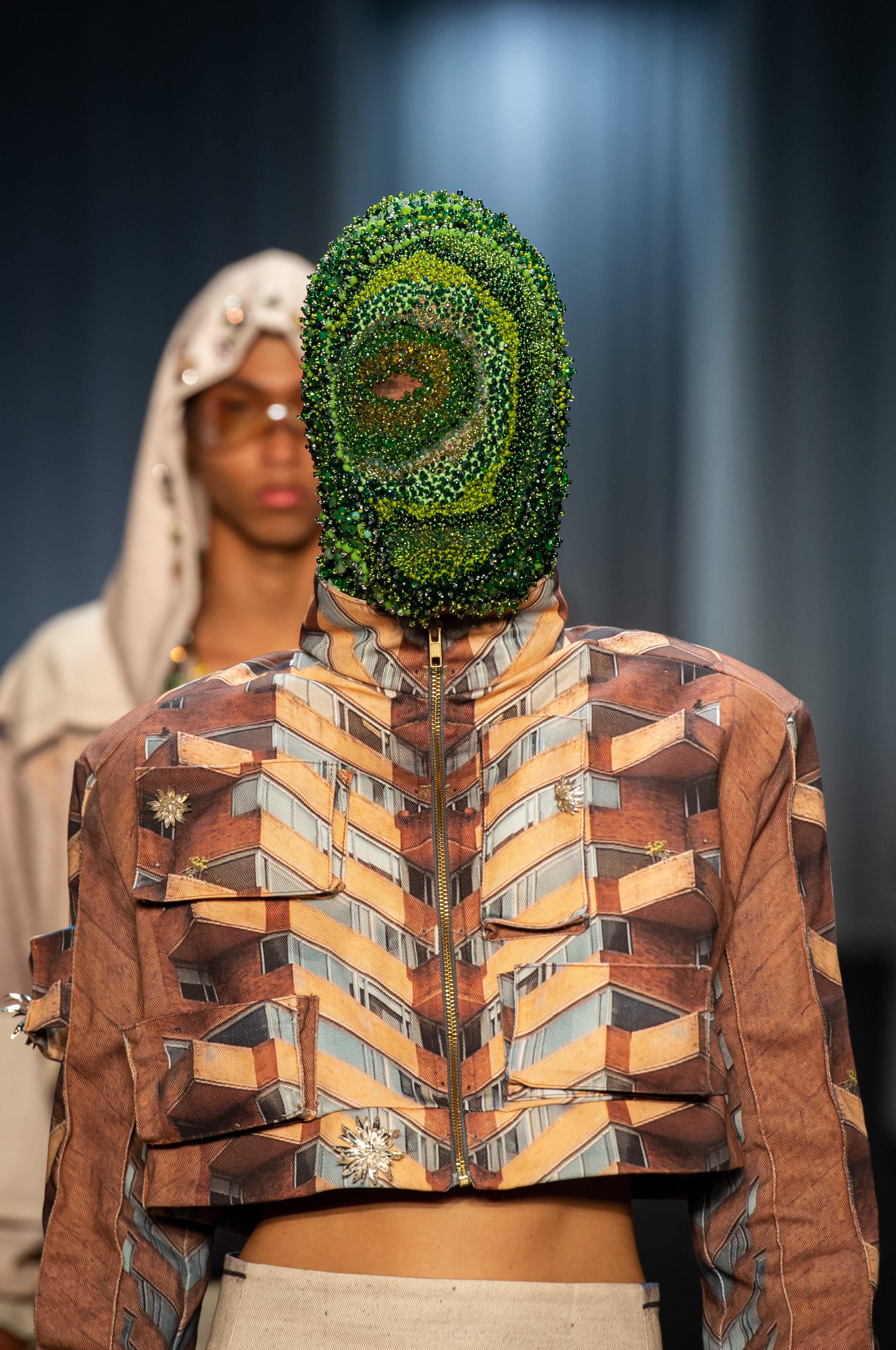 Modelo con un diseño contemporáneo en tonos vivos durante el desfile del Istituto Marangoni en Bogotá.