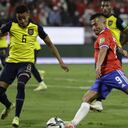 SANTIAGO, CHILE - NOVEMBER 16: Jean Meneses of Chile takes a shot as Byron Castillo of Ecuador defends during a match between Chile and Ecuador as part of FIFA World Cup Qatar 2022 Qualifiers at San Carlos de Apoquindo Stadium on November 16, 2021 in Santiago, Chile. (Photo by Alberto Valdes - Pool/Getty Images)