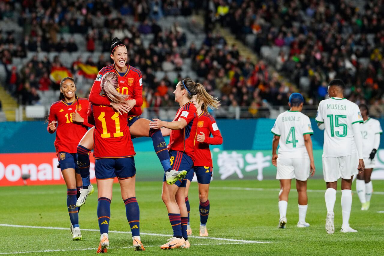 Spain's Jennifer Hermoso jumps into the arms of teammate Alexia Putellas celebrating after scoring her side's second goal during the Women's World Cup Group C soccer match between Spain and Zambia at Eden Park in Auckland, New Zealand, Wednesday, July 26, 2023. (AP Photo/Abbie Parr)