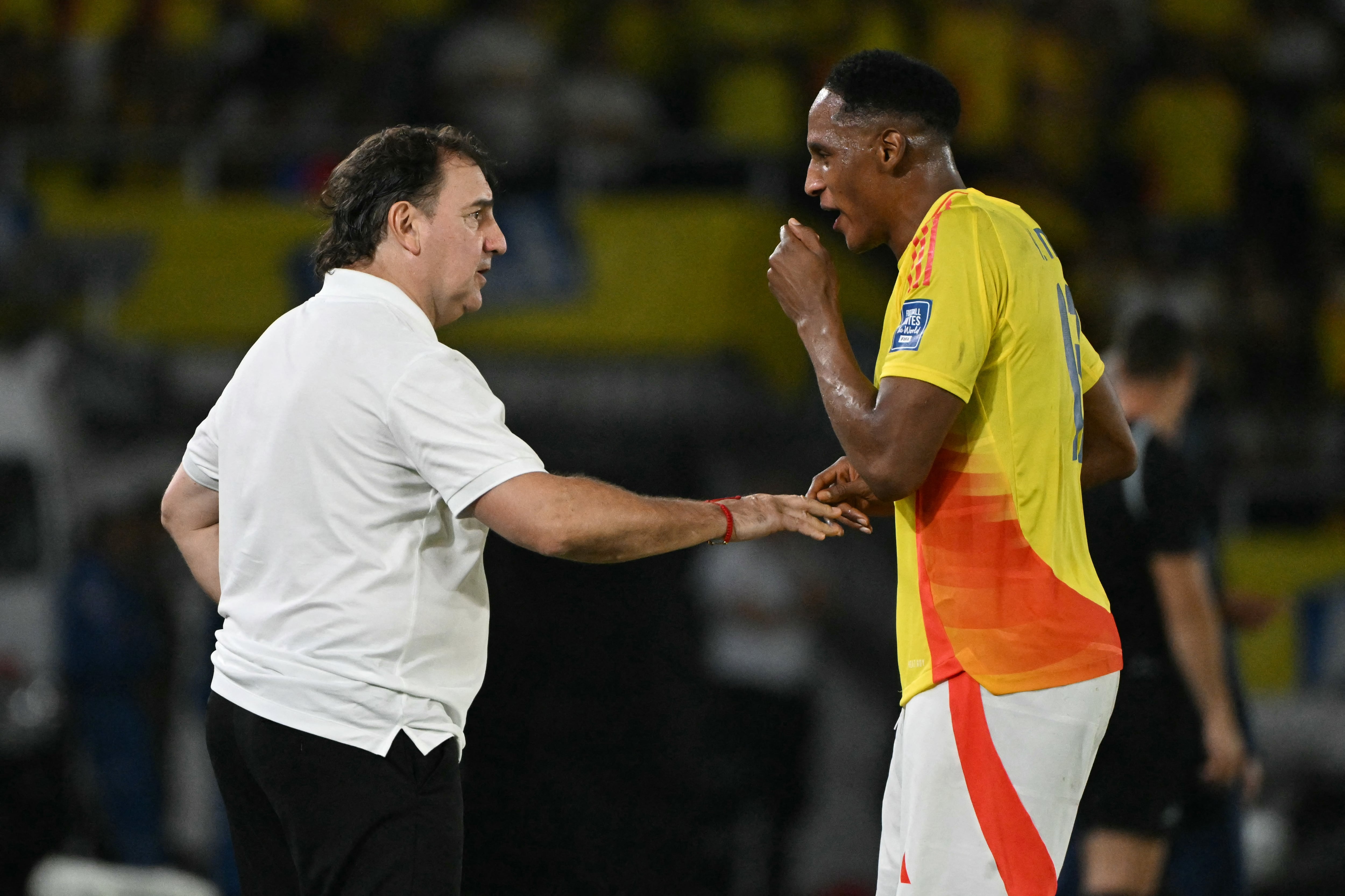 Colombia's Argentine head coach Nestor Lorenzo gives instructions to defender #13 Yerry Mina during the 2026 FIFA World Cup South American qualifiers football match between Colombia and Paraguay at the Metropolitano Roberto Melendez stadium in Barranquilla, Colombia, on March 25, 2025. (Photo by Luis ACOSTA / AFP)