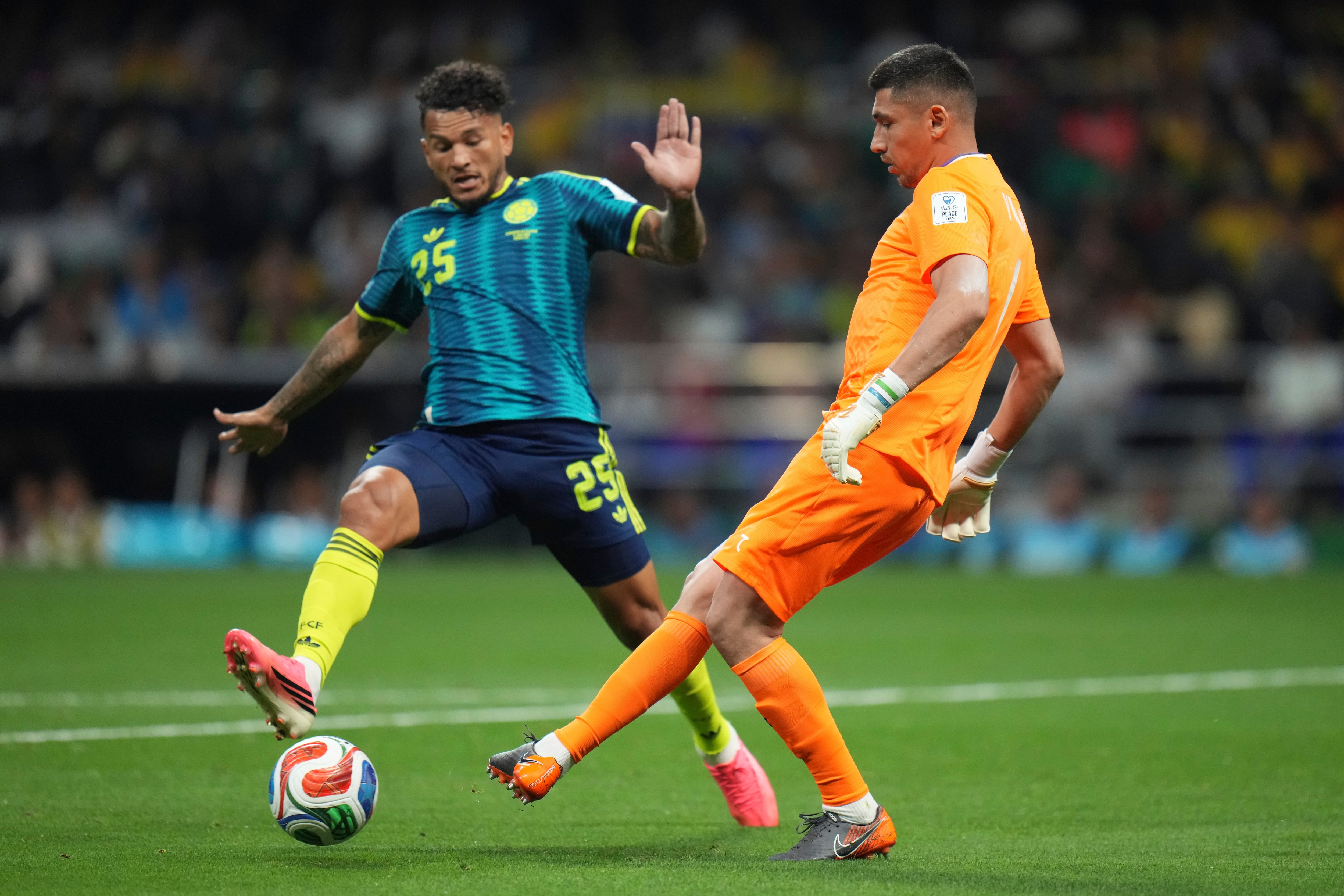 Uzbekistan goalkeeper Utkir Yusupov (1) battles for the ball with Colombia's Luis Suarez (25) during the World Cup Group K soccer match between Uzbekistan and Colombia in Mexico City, Wednesday, June 17, 2026. (AP Photo/Eduardo Verdugo)