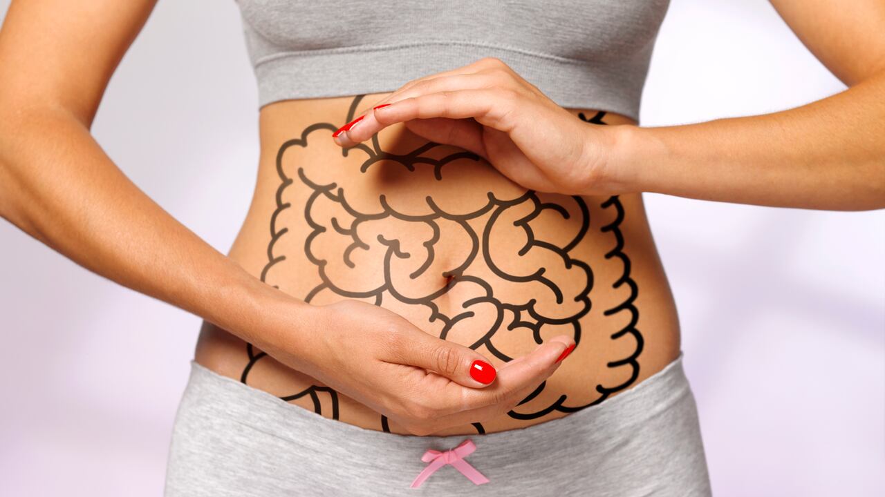 women cradling her internal organs / intestines