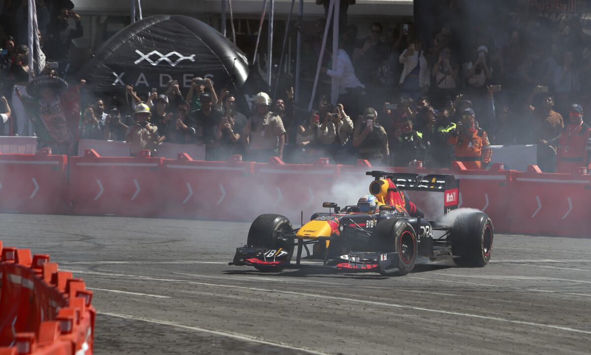 Mexican Formula One Red Bull driver Sergio "Checo" Perez drives in an exhibition race through the streets of Guadalajara, Mexico, Tuesday, Oct. 25, 2022. Perez will compete in the upcoming Mexico Grand Prix in Mexico City. (AP)