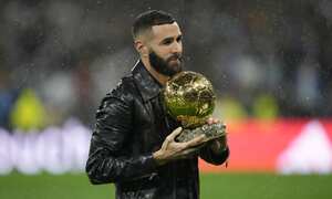 Real Madrid's Karim Benzema holds the 2022 Ballon d'Or trophy prior to the Spanish La Liga soccer match between Real Madrid and Sevilla at the Santiago Bernabeu stadium in Madrid, Saturday, Oct. 22, 2022. (AP Photo/Manu Fernandez)