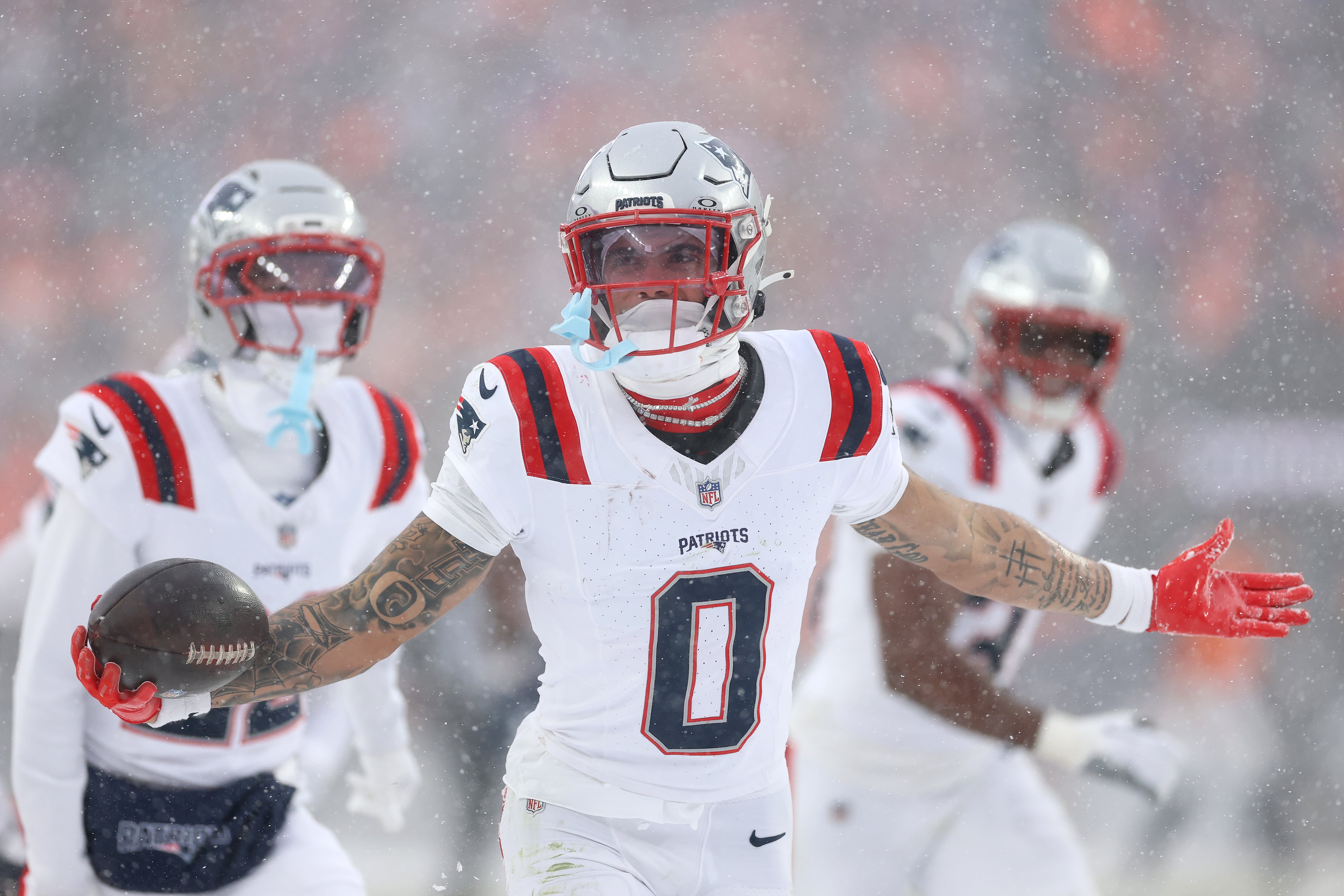 DENVER, COLORADO - JANUARY 25: Christian Gonzalez #0 of the New England Patriots celebrates with teammates after intercepting a pass from Jarrett Stidham #8 of the Denver Broncos (not pictured) intended for Marvin Mims Jr. #19 (not pictured) during the fourth quarter in the AFC Championship Playoff game at Empower Field At Mile High on January 25, 2026 in Denver, Colorado. The New England Patriots defeat the Denver Broncos 10-7. (Photo by Matthew Stockman/Getty Images)