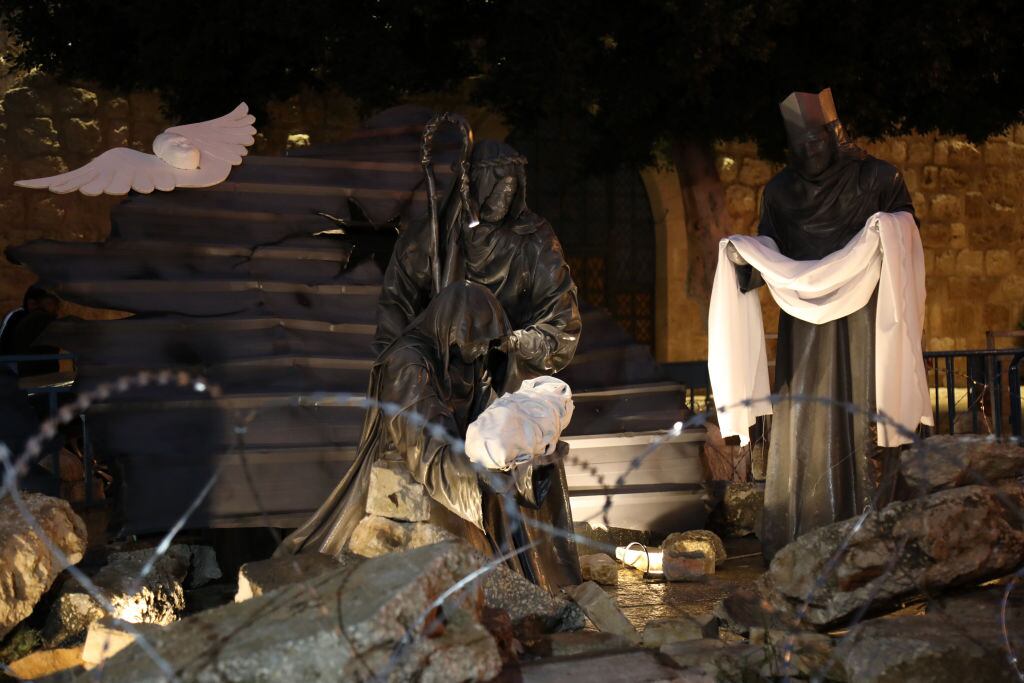 BETHLEHEM, WEST BANK - DECEMBER 23: A view of the barbed wires and decorations made from debris symbolizing the destruction in Gaza near the Church of the Nativity, built on a cave where Jesus Christ is believed to have been born, as all Christmas celebrations are limited due to the Israeli-Palestinian conflict in Bethlehem, West Bank on December 23, 2023. Due to Israel's attacks on Gaza, the streets of the city were not decorated for Christmas this year as in previous years. In the city, where festive activities were avoided, the streets were not decorated with lights as in previous years and the Christmas tree in front of the Church of the Nativity (Mehd) was not illuminated. While the courtyard of the Church of the Nativity is filled with visitors every year, this year it was almost empty. (Photo by Wesam Hashlamon/Anadolu via Getty Images)