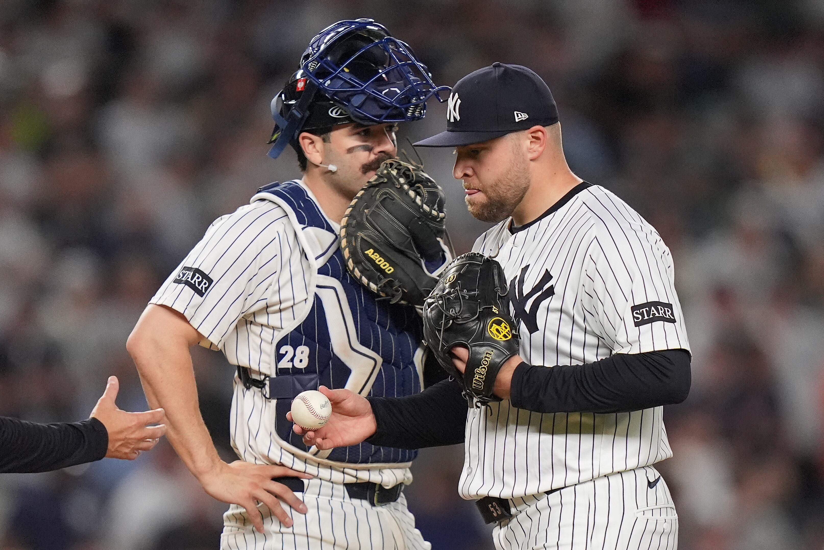 New York Yankees pitcher David Bednar, right, leaves the game after giving up an RBI double to the Boston Red Sox during the ninth inning of Game 1 of an American League wild-card baseball playoff series, Tuesday, Sept. 30, 2025, in New York. (AP Photo/Frank Franklin II)