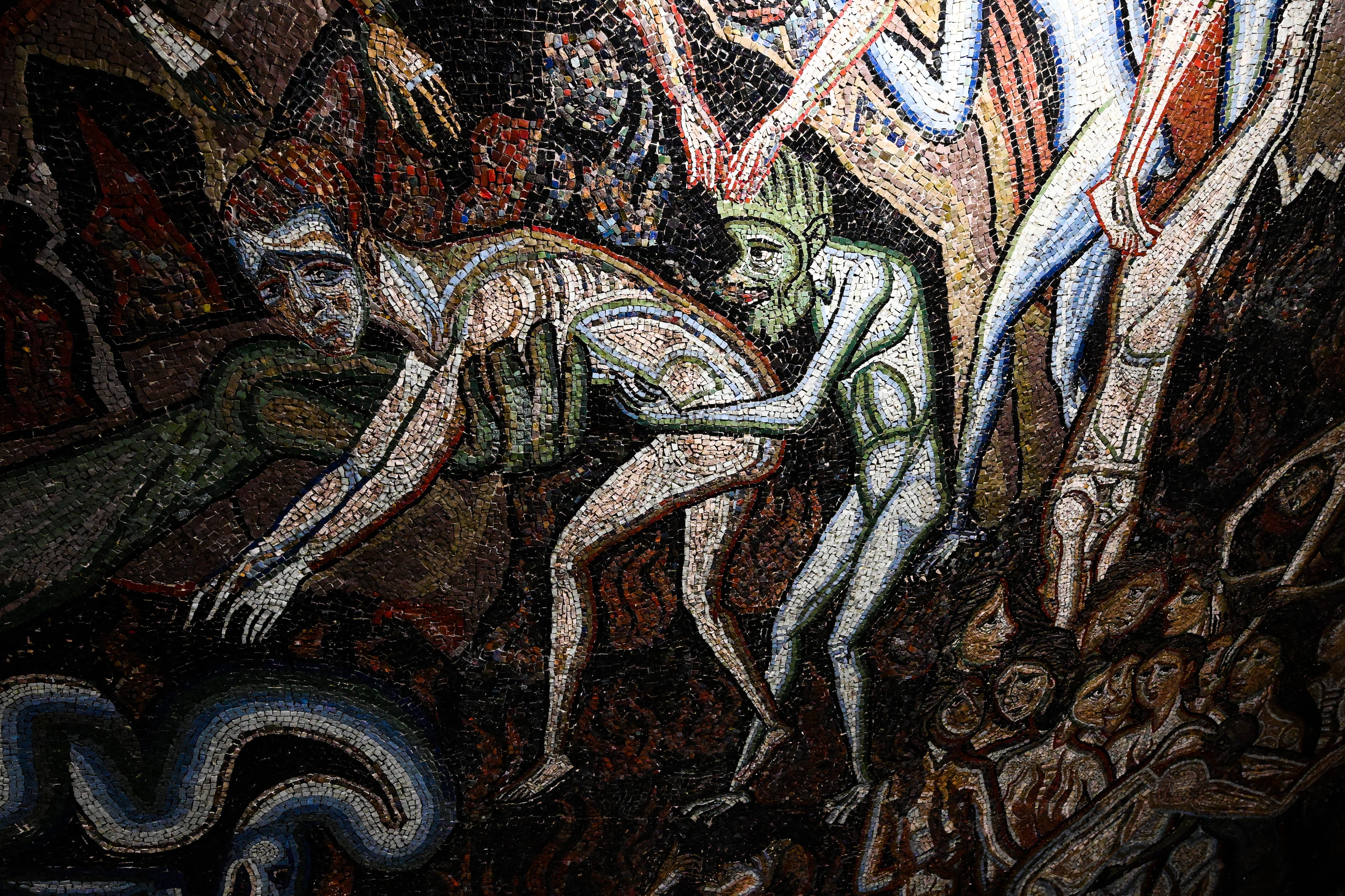 A view shows a detail of the section "Inferno" (Hell) of the mosaic ceiling of the Baptistery of San Giovanni, one of the most ancient churches in Florence, Tuscany, during the presentation of the start of a six-year restoration of its mosaic ceiling, on February 8, 2023. - The mosaic ceiling of the Florence Baptistery, a set of mosaics covering the internal dome and apses, is one of the most important cycles of medieval Italian mosaics, created between 1225 and around 1330 using designs by major Florentine painters. (Photo by Vincenzo PINTO / AFP)