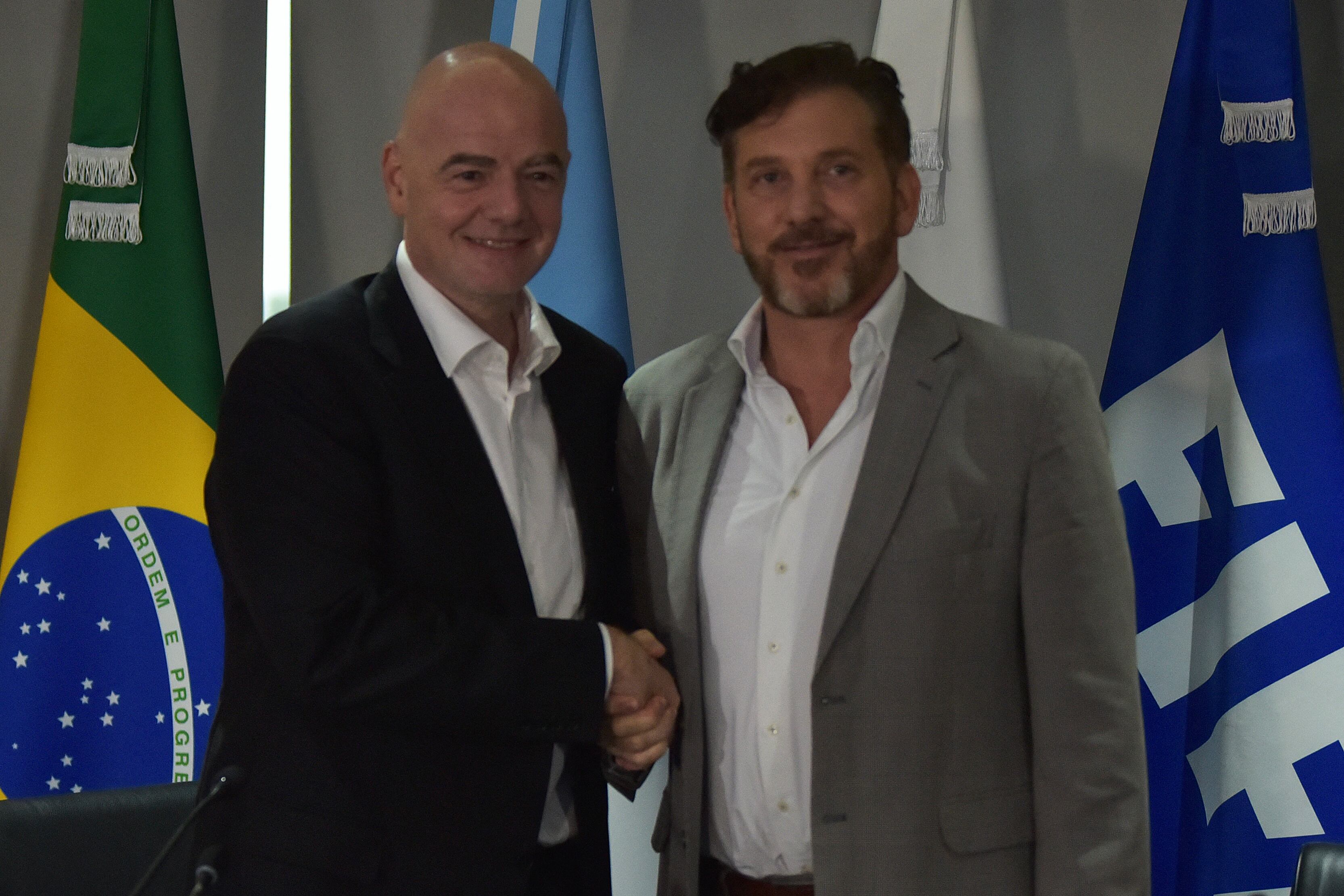FIFA President Gianni Infantino (L) and the president of Conmebol, Paraguayan Alejandro Dominguez, pose for a picture at the end of a press conference at Conmebol's headquarters in Luque, Paraguay, on March 30, 2023. (Photo by NORBERTO DUARTE / AFP)