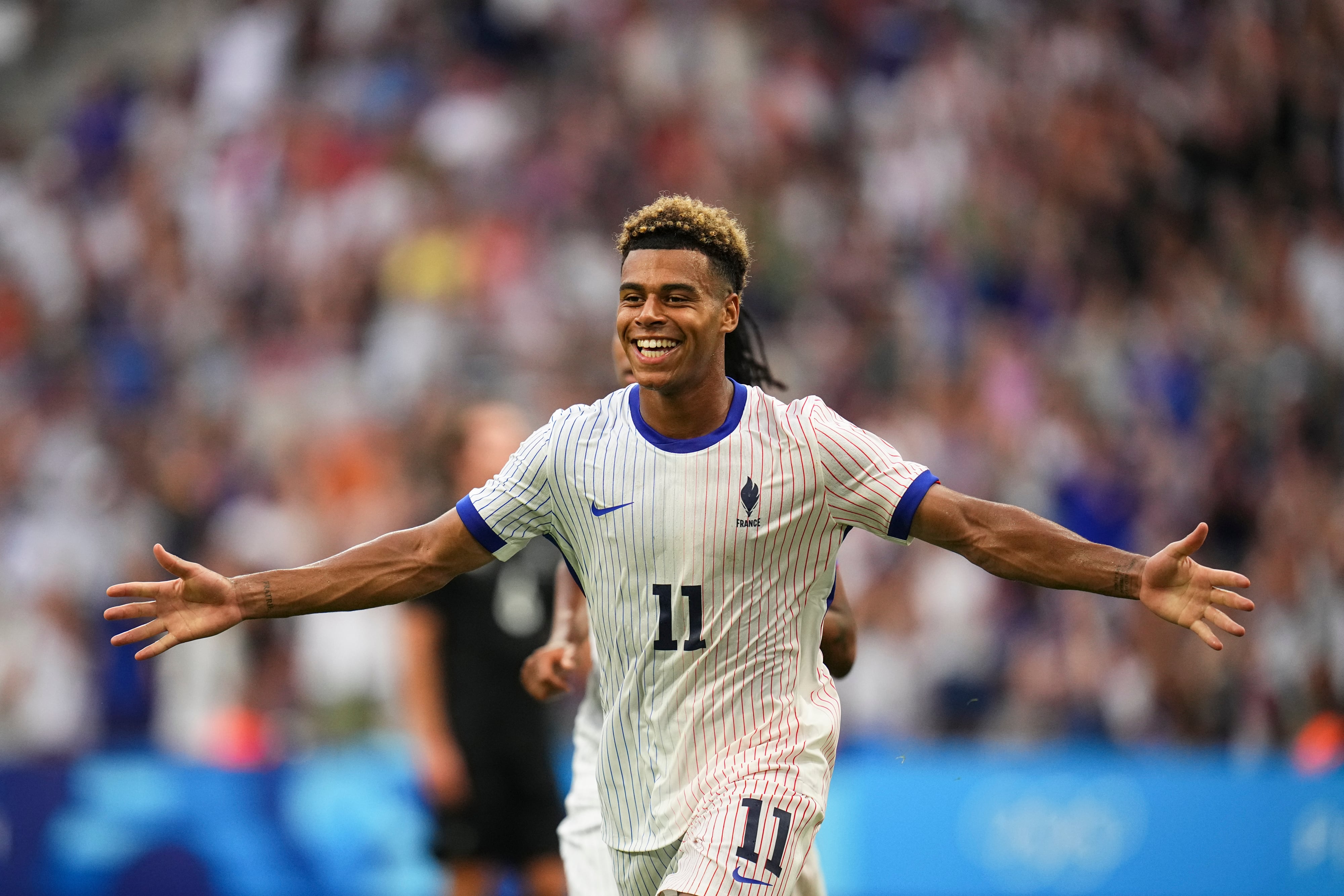 France's Desire Doue celebrates after scoring his side's second goal during the men's Group A soccer match between New Zealand and France at the Velodrome Stadium, during the 2024 Summer Olympics, Tuesday, July 30, 2024, in Marseille, France. (AP Photo/Daniel Cole)