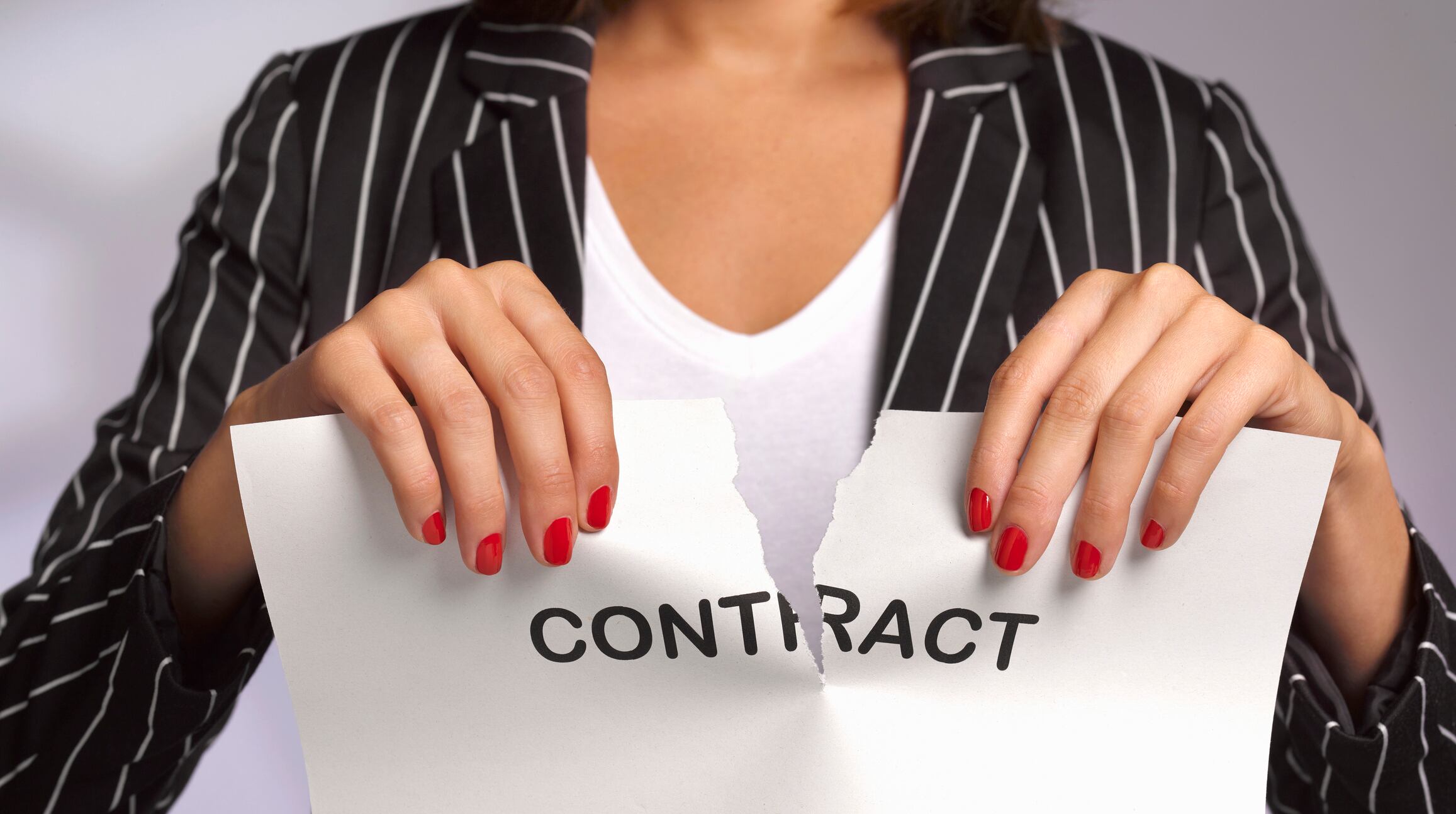 business woman tearing and rejecting her work contract