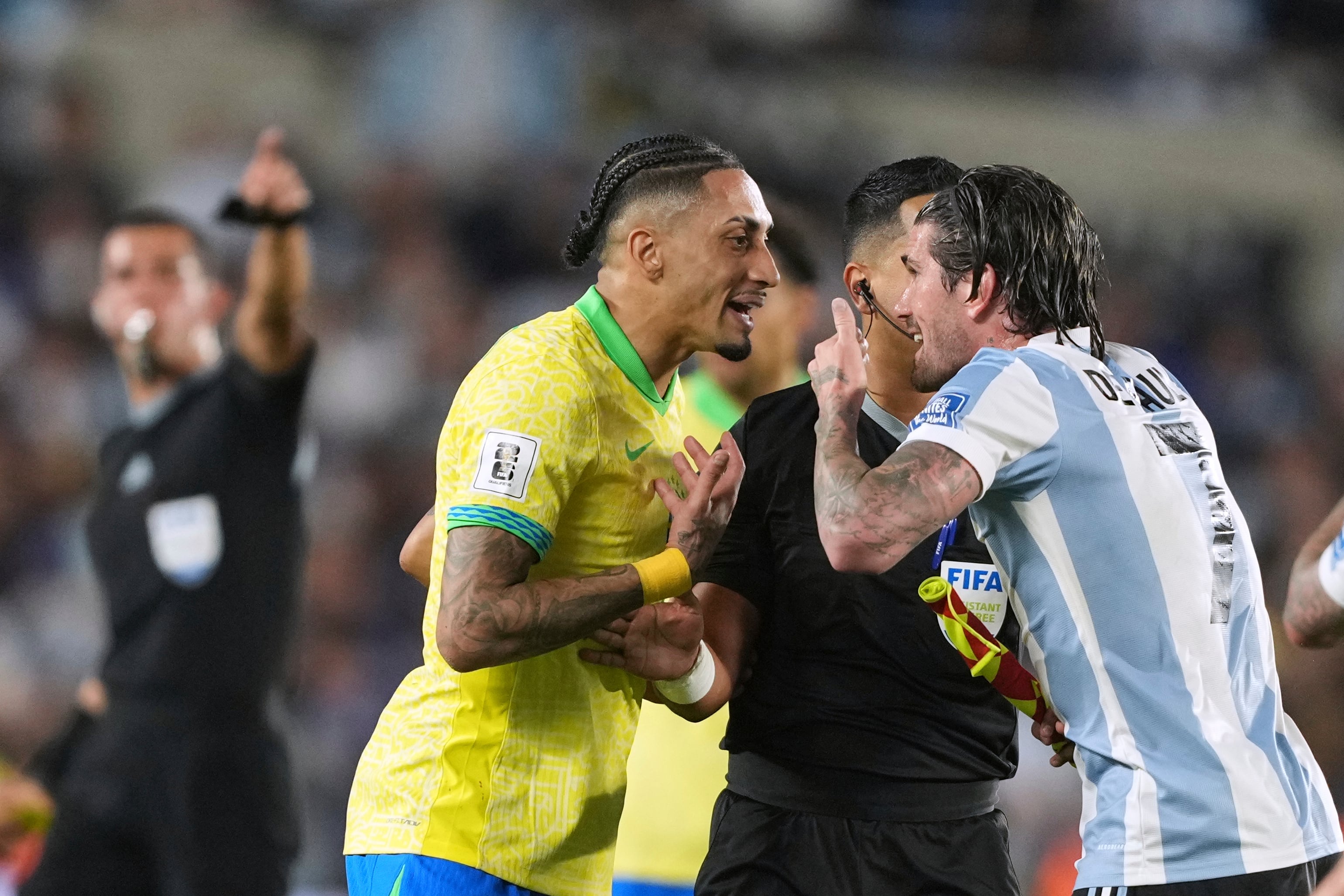Brazil's Raphinha left, and Argentina's Rodrigo De Paul argue during a World Cup 2026 qualifying soccer match at Monumental Stadium in Buenos Aires, Argentina, Tuesday, March 25, 2025. (AP Photo/Natacha Pisarenko)
