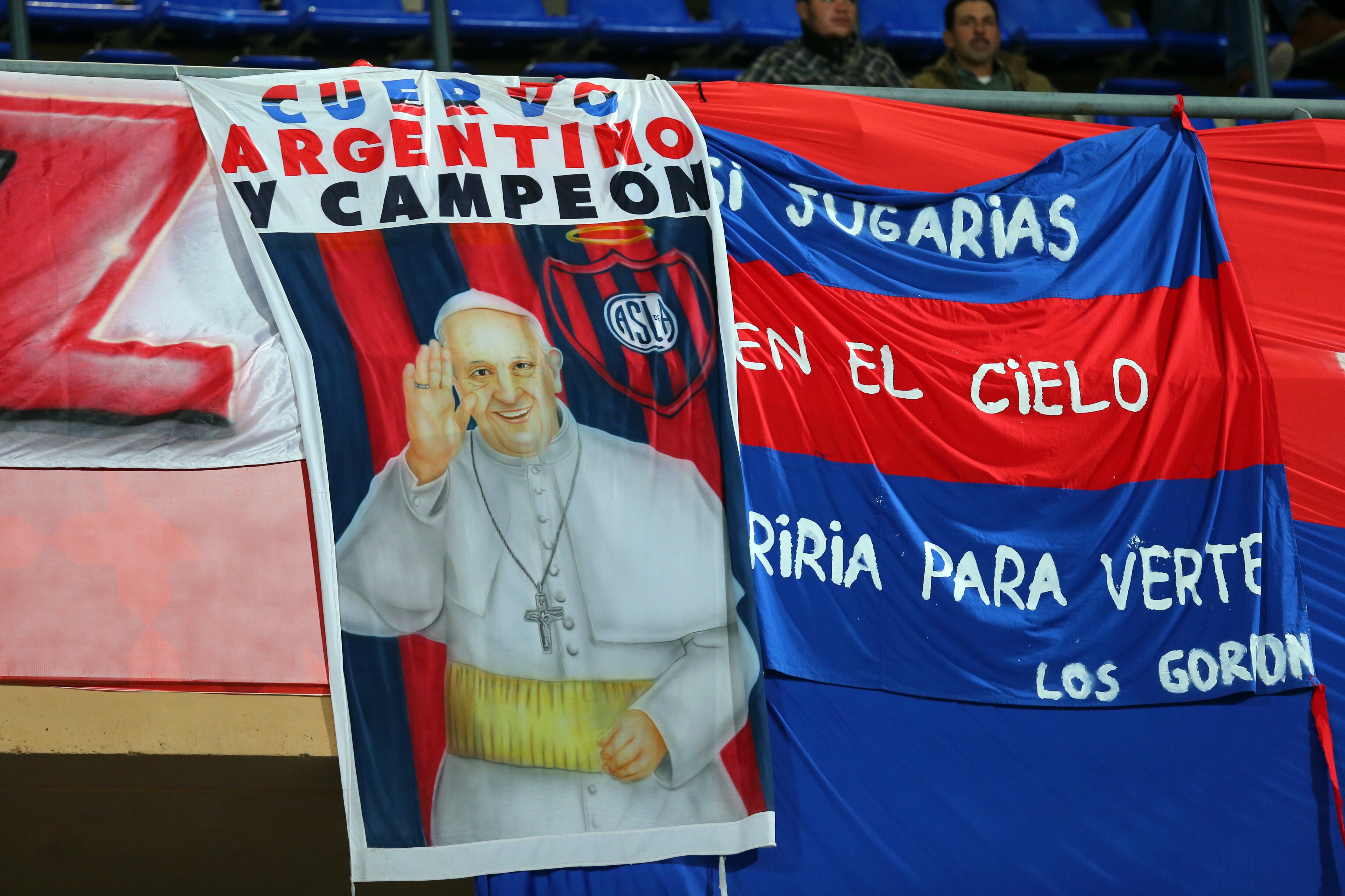 Fans of San Lorenzo display an image of The Pope, Pope Francis (Photo by AMA/Corbis via Getty Images)