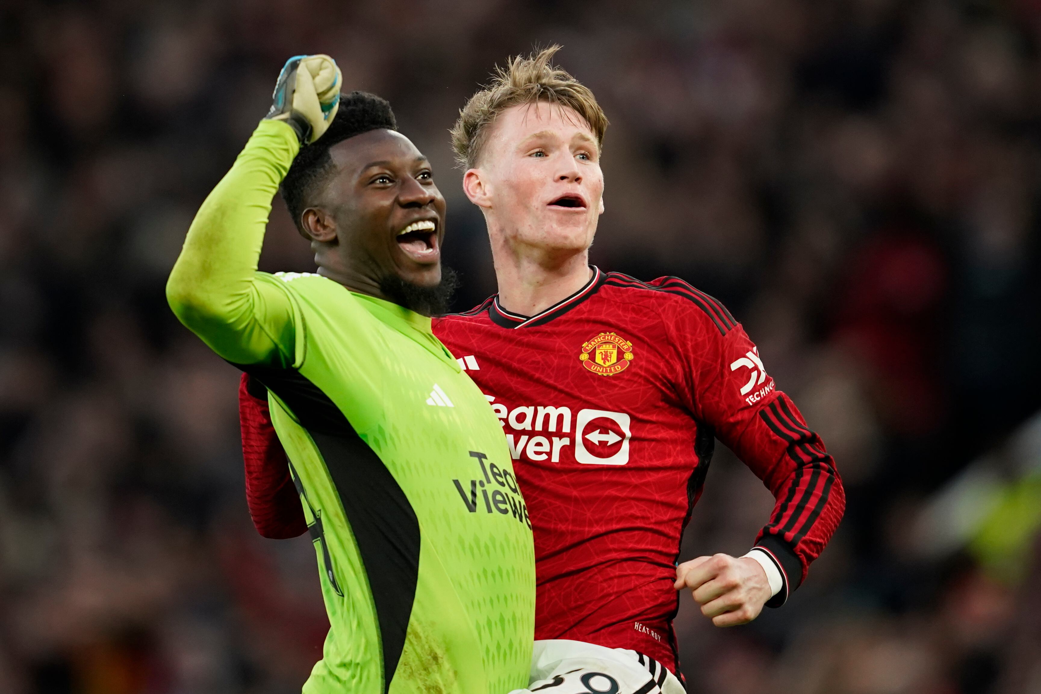 Manchester United's Scott McTominay, right, celebrates with Manchester United's goalkeeper Andre Onana at full time of the FA Cup quarterfinal soccer match between Manchester United and Liverpool at the Old Trafford stadium in Manchester, England, Sunday, March 17, 2024. Manchester United won 4-3. (AP Photo/Dave Thompson)