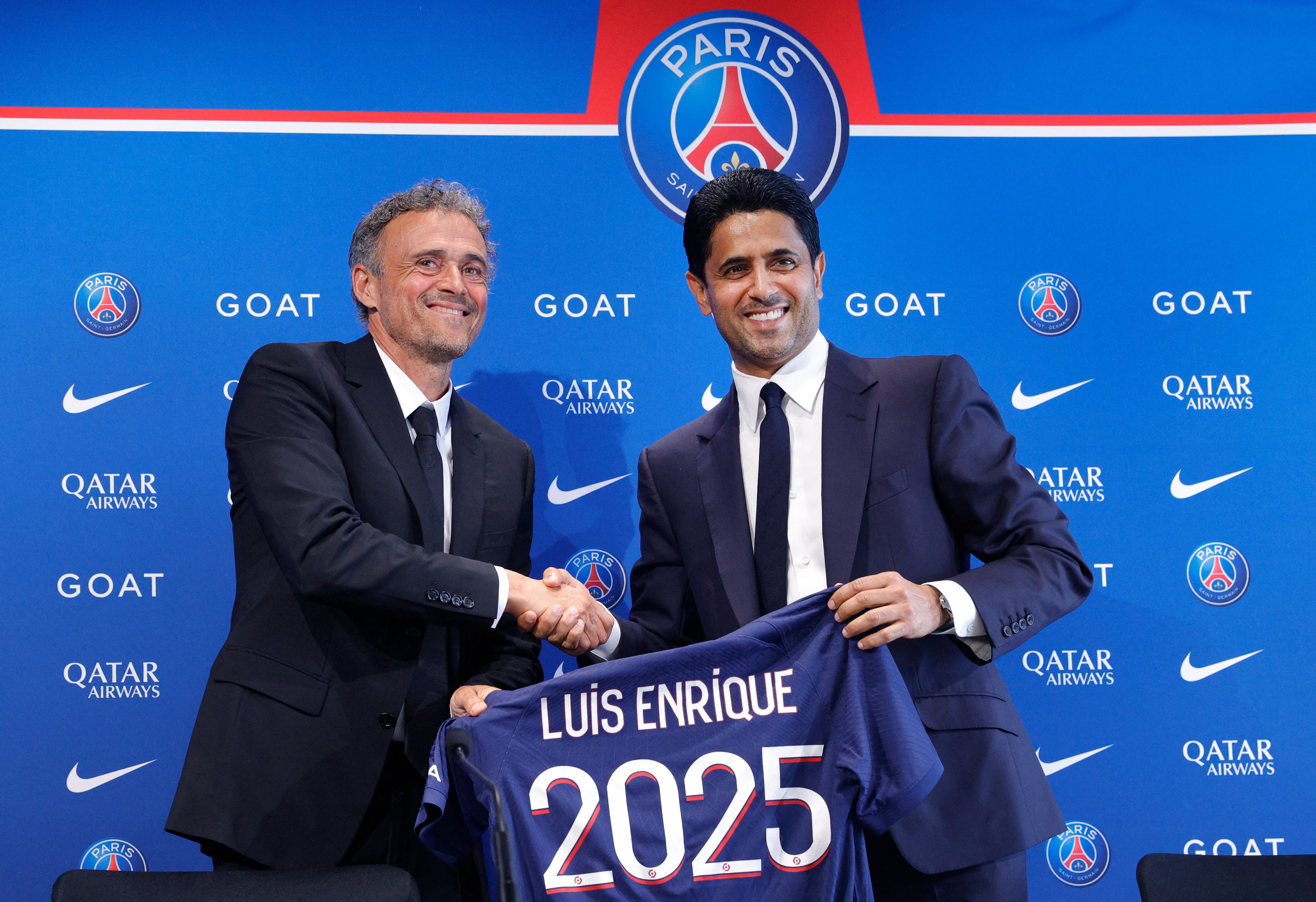 Paris Saint-Germain's newly appointed Spanish head coach Luis Enrique (L) shakes hands with Paris Saint Germain's Qatari president Nasser al-Khelaifi during a press conference to announce the presentation of the new coach, at the new 'campus' of French L1 Paris Saint-Germain (PSG) football club at Poissy, west of Paris on July 5, 2023. Former Barcelona and Spain coach Luis Enrique has been appointed as the new coach of Paris Saint-Germain on a two-year deal, the French champions announced on July 5, 2023. (Photo by Geoffroy Van der Hasselt / AFP)