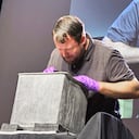 Paul Hudson, West Point archeologist, takes part in the opening of a lead box believed to have been placed in the base of a monument by cadets almost two centuries ago, at the U.S. Military Academy, Monday, Aug. 28, 2023, in West Point, N.Y. The box contained silt. (AP Photo/Michael Hill)