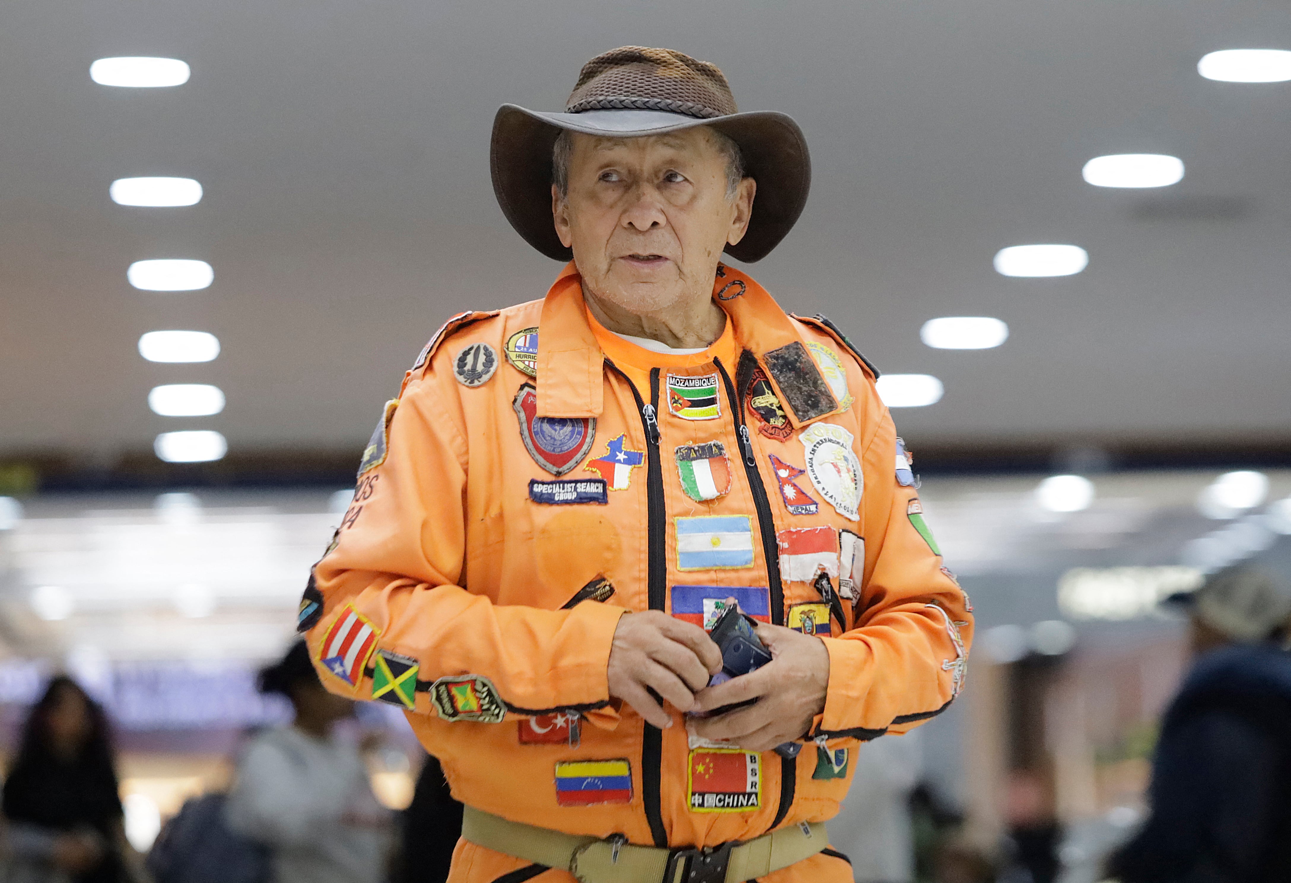 Héctor «El Chino» Méndez, rescatista y fundador de Topos Azteca México, vestido con un mono naranja, llega al Aeropuerto Internacional de la Ciudad de México el 25 de junio de 2026 para viajar a Venezuela y brindar asistencia tras el reciente terremoto que causó graves daños en el país sudamericano.