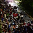 More than a thousand of Honduran people leave in a caravan to the United States, from San Pedro Sula, at a bus terminal, 240 kms north of Tegucigalpa, on October 1, 2020. - The caravan of migrants are chasing the American dream in the midst of the Covid-19, which registers more than 2,300 deaths in Honduras. (Photo by ORLANDO SIERRA / AFP)