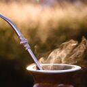 mate bowl, outdoors. Yerba mate typical of Argentina, Brazil and Uruguay. Mountain scenery in the background. It consists of a gourd, a pump, ground yerba mate and warm water.