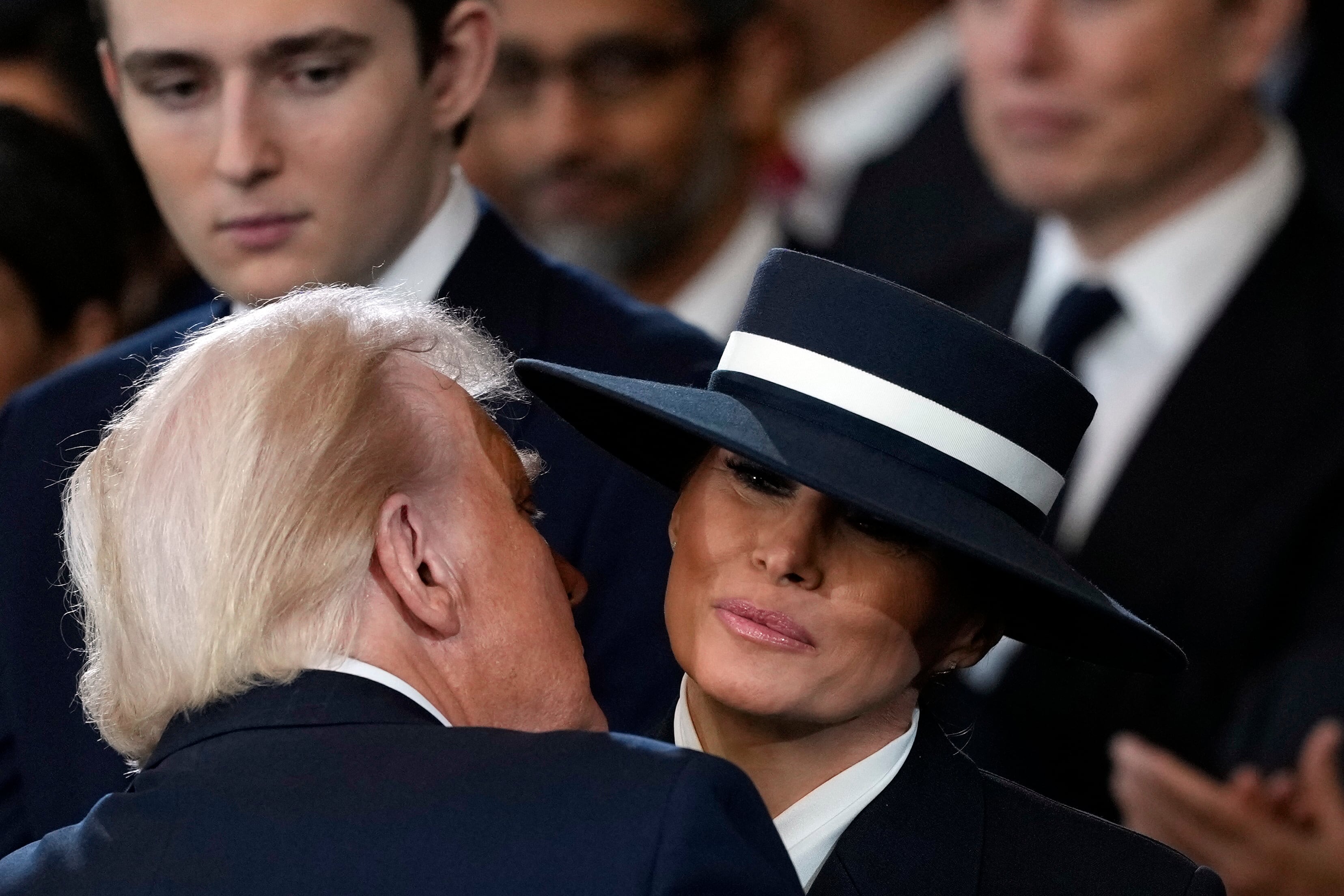 WASHINGTON, DC - JANUARY 20: U.S. President Donald Trump and Melania Trump kiss during his swearing in in the U.S. Capitol Rotunda on January 20, 2025 in Washington, DC. Donald Trump takes office for his second term as the 47th president of the United States. (Photo by Julia Demaree Nikhinson - Pool/Getty Images)