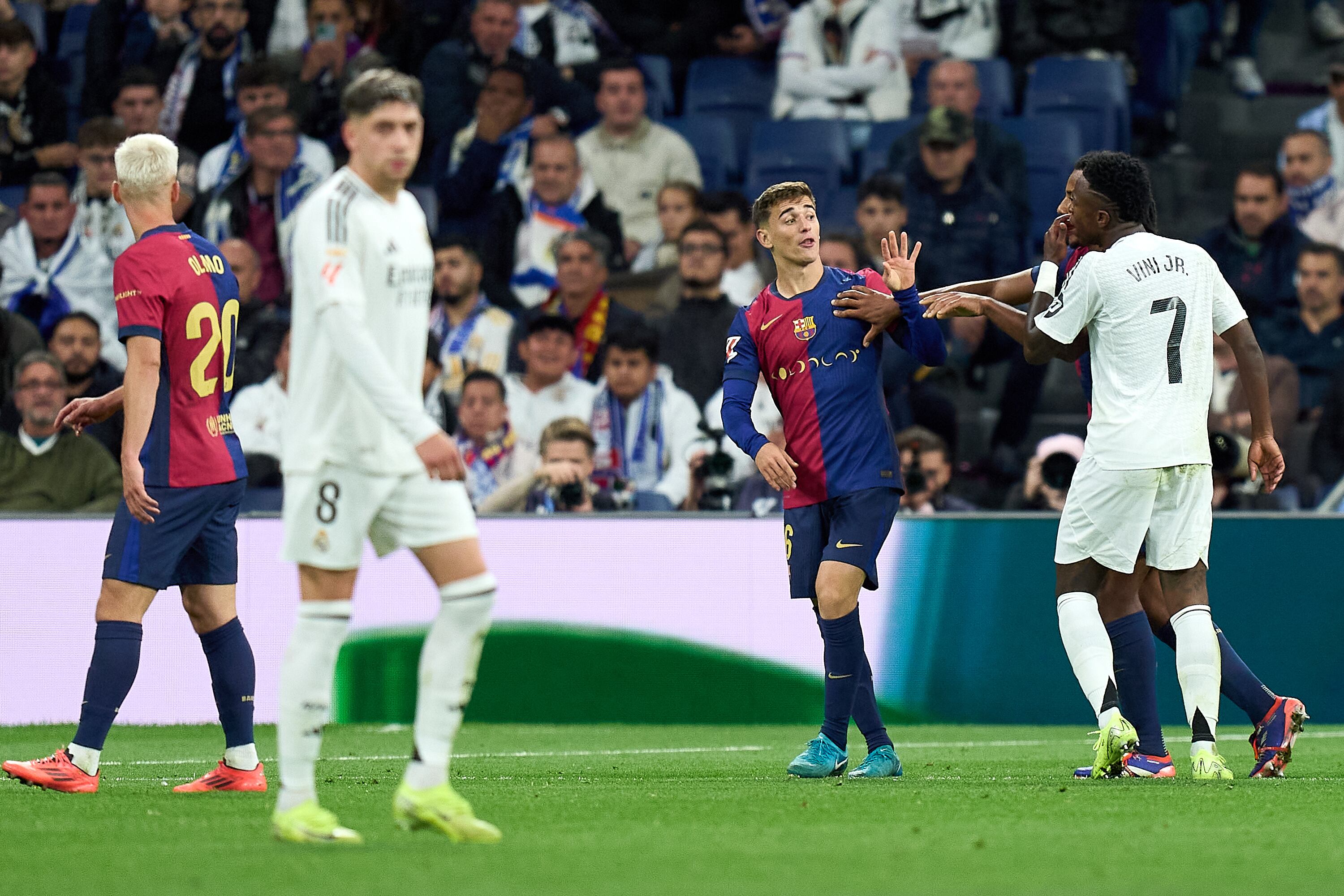 Gavi del FC Barcelona y Vinicius Junior del Real Madrid chocan durante el partido de LaLiga entre el Real Madrid CF y el FC Barcelona en el Estadio Santiago Bernabeu el 26 de octubre de 2024 en Madrid, España.