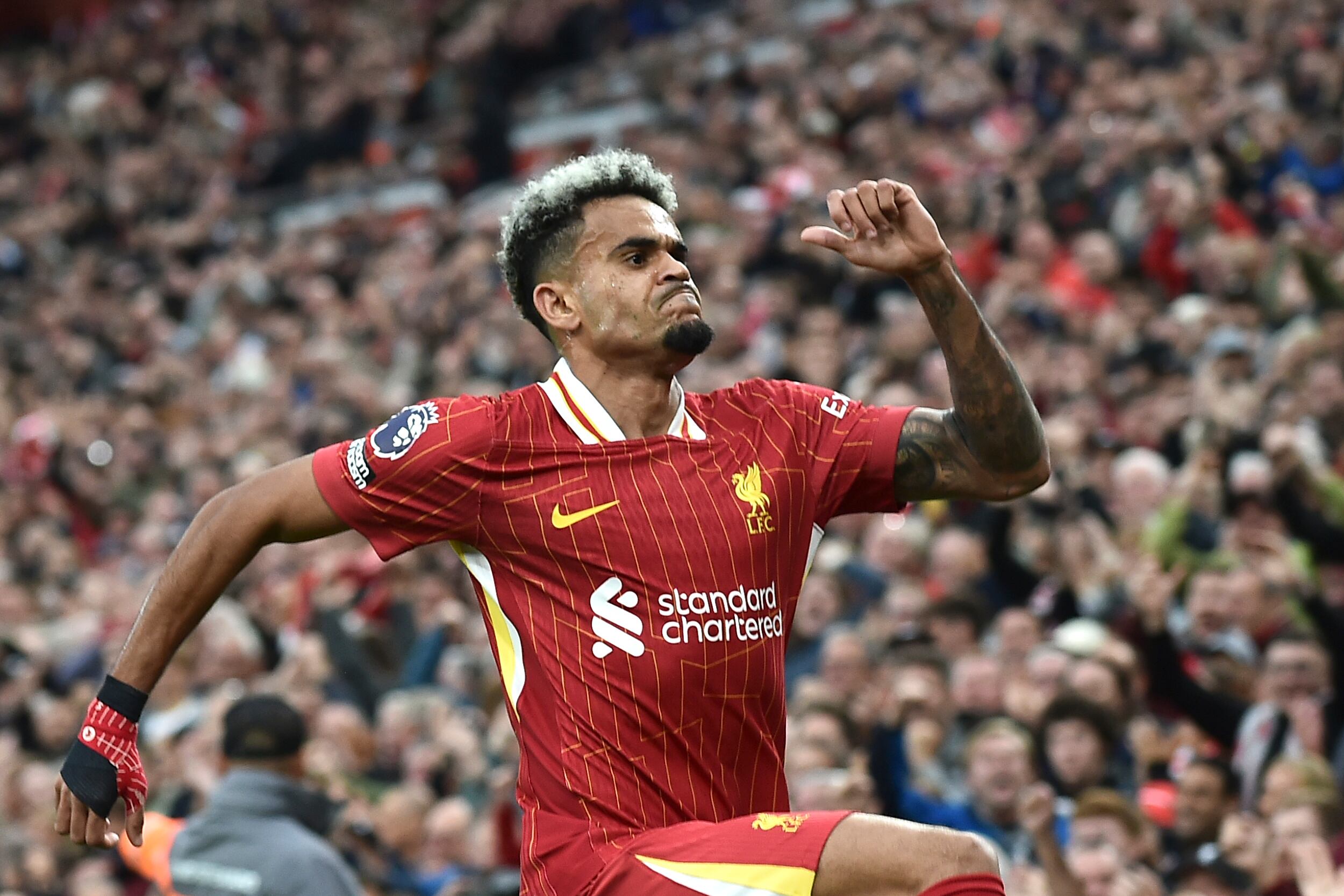 Liverpool's Luis Diaz celebrates after scoring his side's opening goal during the English Premier League soccer match between Liverpool and Brentford at Anfield Stadium, Liverpool, England, Sunday, Aug. 25, 2024. (AP Photo/Rui Vieira)