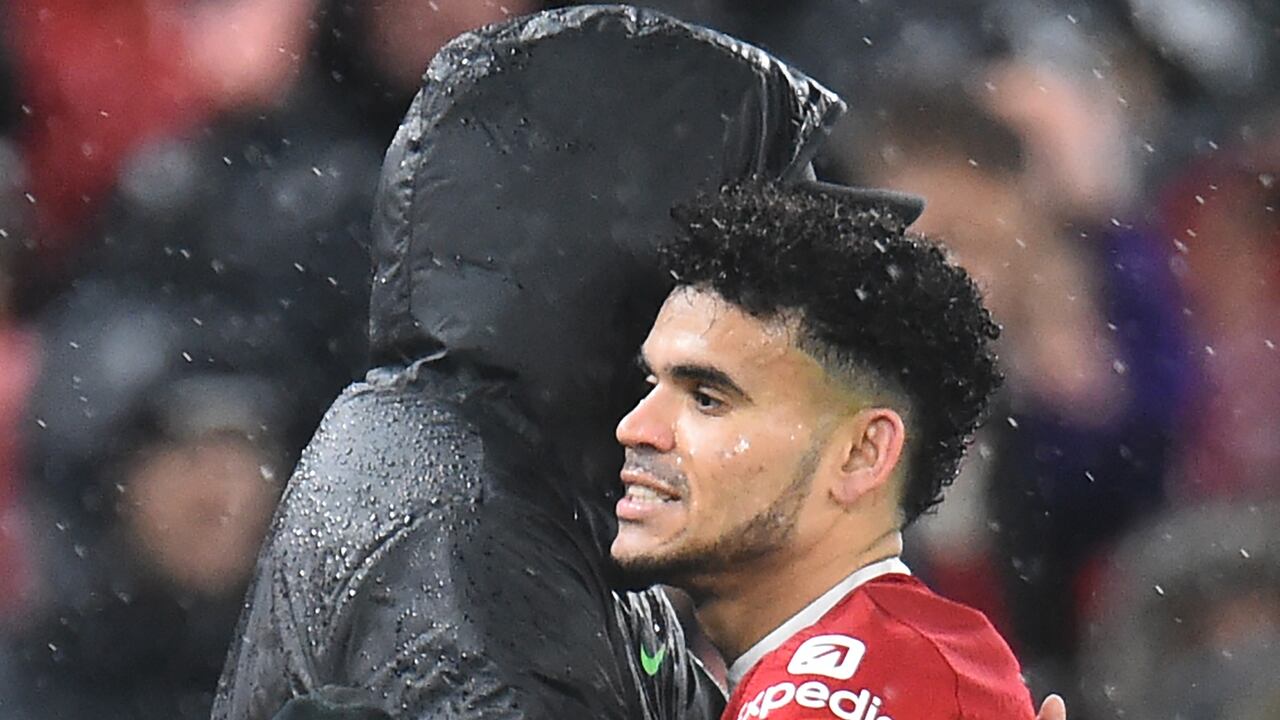Liverpool's German manager Jurgen Klopp (L) embraces Liverpool's Colombian midfielder #07 Luis Diaz (R) after he is substituted during the English Premier League football match between Liverpool and Newcastle United at Anfield in Liverpool, north west England on January 1, 2024. (Photo by PETER POWELL / AFP) / RESTRICTED TO EDITORIAL USE. No use with unauthorized audio, video, data, fixture lists, club/league logos or 'live' services. Online in-match use limited to 120 images. An additional 40 images may be used in extra time. No video emulation. Social media in-match use limited to 120 images. An additional 40 images may be used in extra time. No use in betting publications, games or single club/league/player publications. /