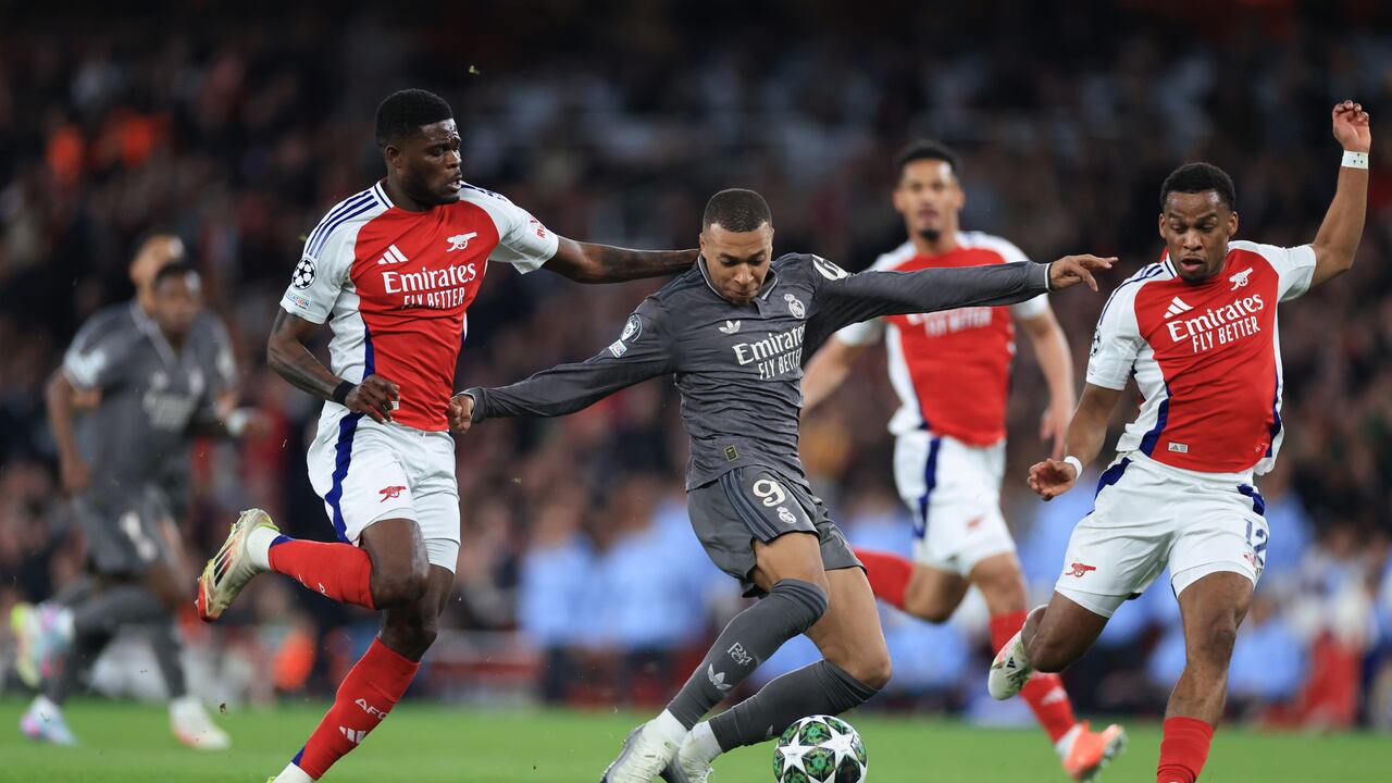 LONDON, ENGLAND - APRIL 08: Kylian Mbappe of Real Madrid runs with the ball under pressure from Thomas Partey and Jurrien Timber of Arsenal during the UEFA Champions League 2024/25 Quarter Final First Leg match between Arsenal FC and Real Madrid C.F. at Arsenal Stadium on April 08, 2025 in London, England. (Photo by Marc Atkins/Getty Images)