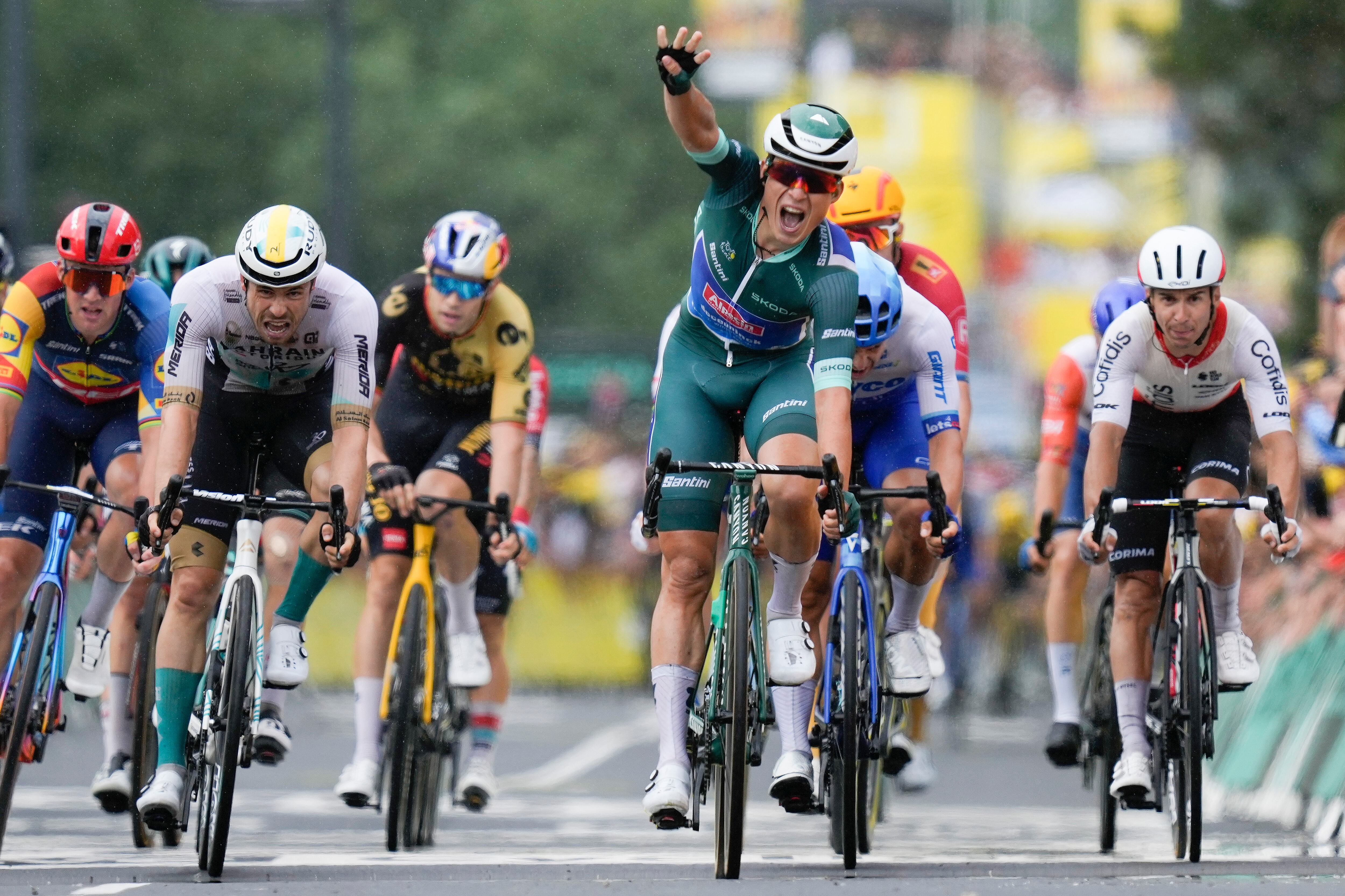 Belgium's Jasper Philipsen flashes four fingers for his fourth stage victory as he crosses the finish line ahead of 164m just behind Philipsen, and Germany's Phil Bauhaus, second left, as he crosses the finish line to win the eleventh stage of the Tour de France cycling race over 180 kilometers (112 miles) with start in Clermont-Ferrand and finish in Moulins, France, Wednesday, July 12, 2023. (AP Photo/Thibault Camus)
