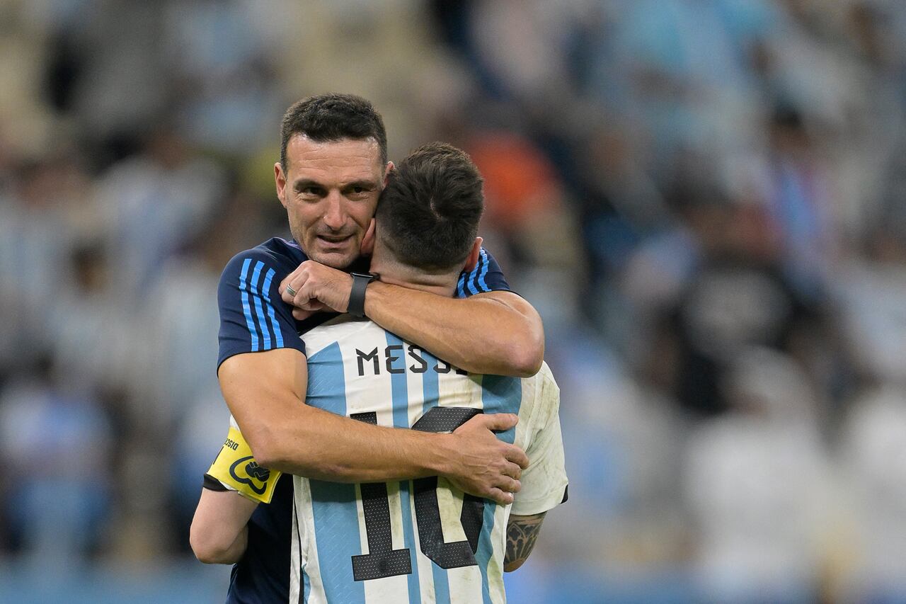 Argentina's forward #10 Lionel Messi is embraced by Argentina's coach #00 Lionel Scaloni after their team's victory in the Qatar 2022 World Cup quarter-final football match between The Netherlands and Argentina at Lusail Stadium, north of Doha on December 9, 2022. (Photo by JUAN MABROMATA / AFP)
