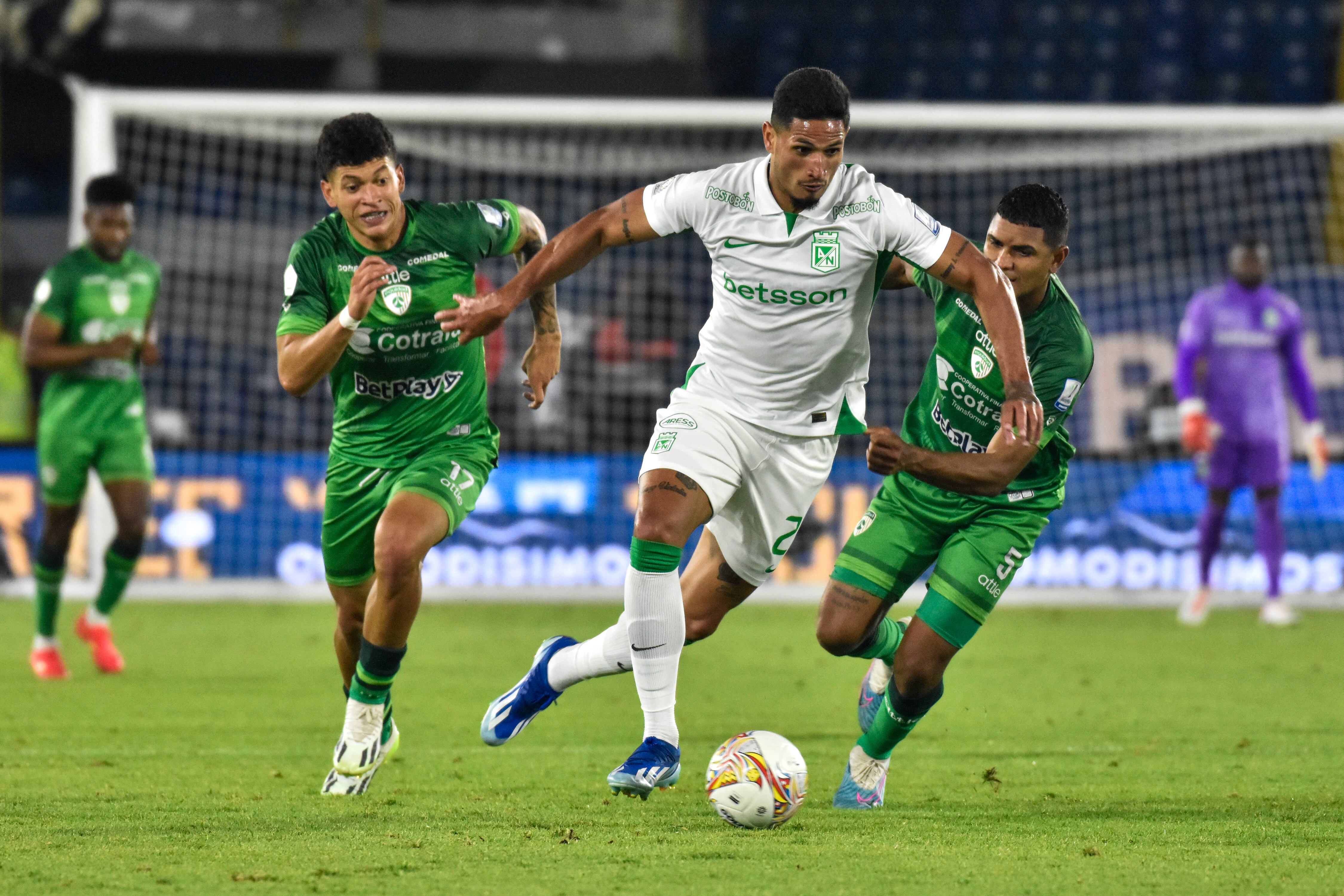 Atletico Nacional's Eric Ramirez (C) fights the ball against Equidad's Elan Joshep Ricardo Ochoa (L) and Martin Payares (R) during the BetPlay Dimayor Leagua match between Equidad (2) and Nacional (0) in Bogota, Colombia's El Campin stadium on February 25, 2024. (Photo by: Cristian Bayona/Long Visual Press/Universal Images Group via Getty Images)