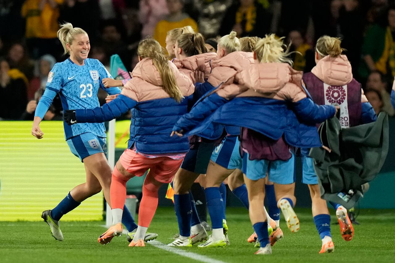 England's Alessia Russo, left, celebrates with teammates after scoring her side's third goal during the Women's World Cup semifinal soccer match between Australia and England at Stadium Australia in Sydney, Australia, Wednesday, Aug. 16, 2023. (AP Photo/Rick Rycroft)