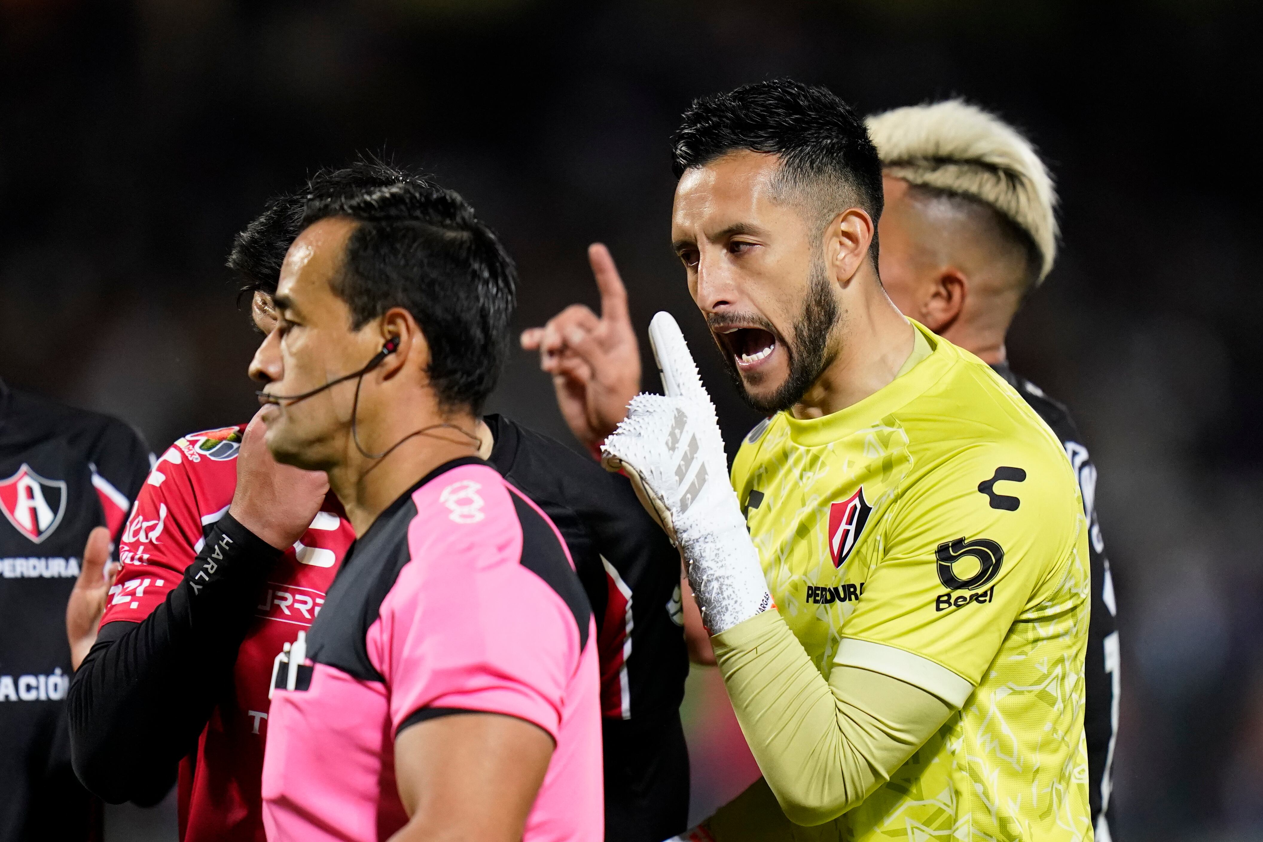 Atlas' goalkeeper Camilo Vargas, right, protests to referee Jorge Rojas during the first leg match against Pumas of the Mexican soccer league semi final in Mexico City, Thursday, Dec. 2, 2021. (AP Photo/Eduardo Verdugo)