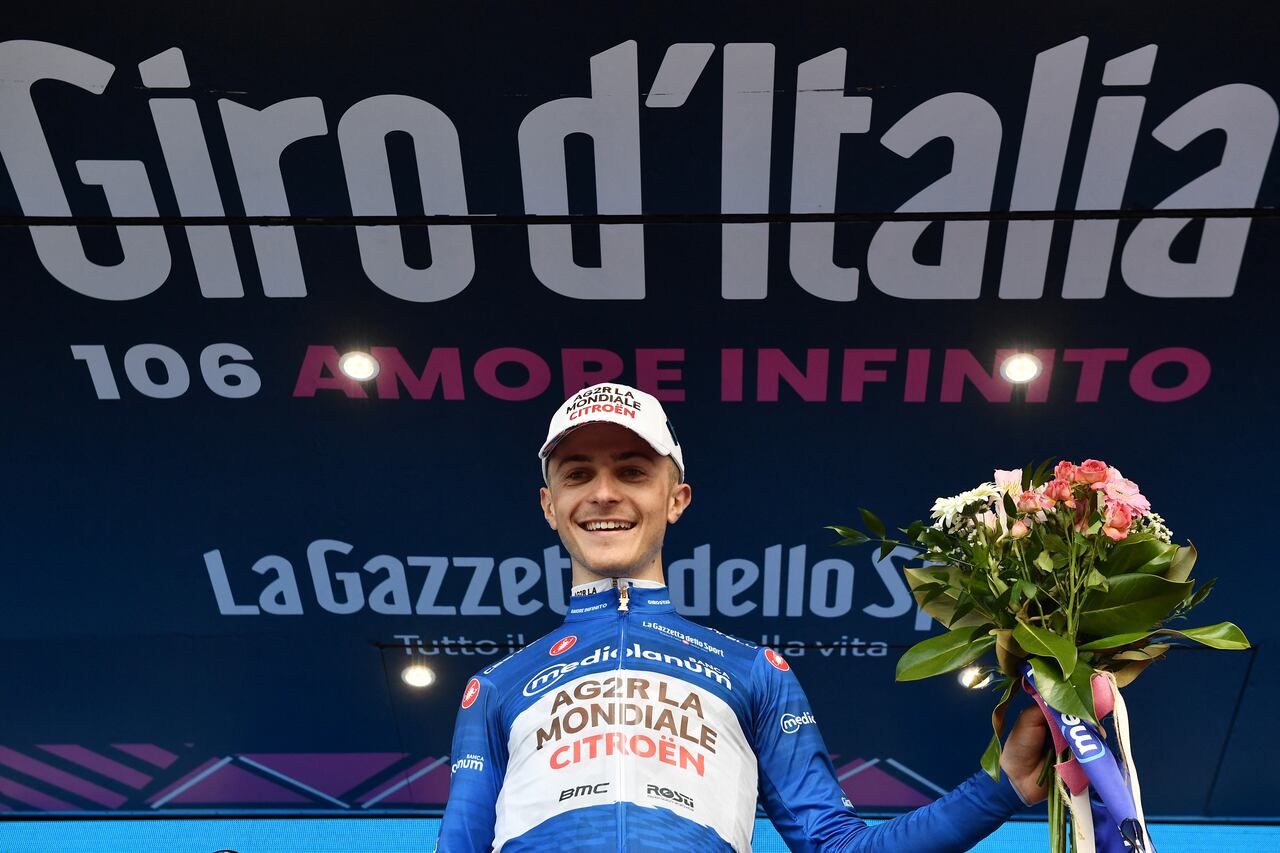 Cycling - Giro d'Italia - Stage 2 - Teramo to San Salvo - Italy - May 7, 2023 AG2R Citroen's Paul Lapeira celebrates on the podium wearing the maglia azzurra jersey to stage 2 REUTERS/Jennifer Lorenzini