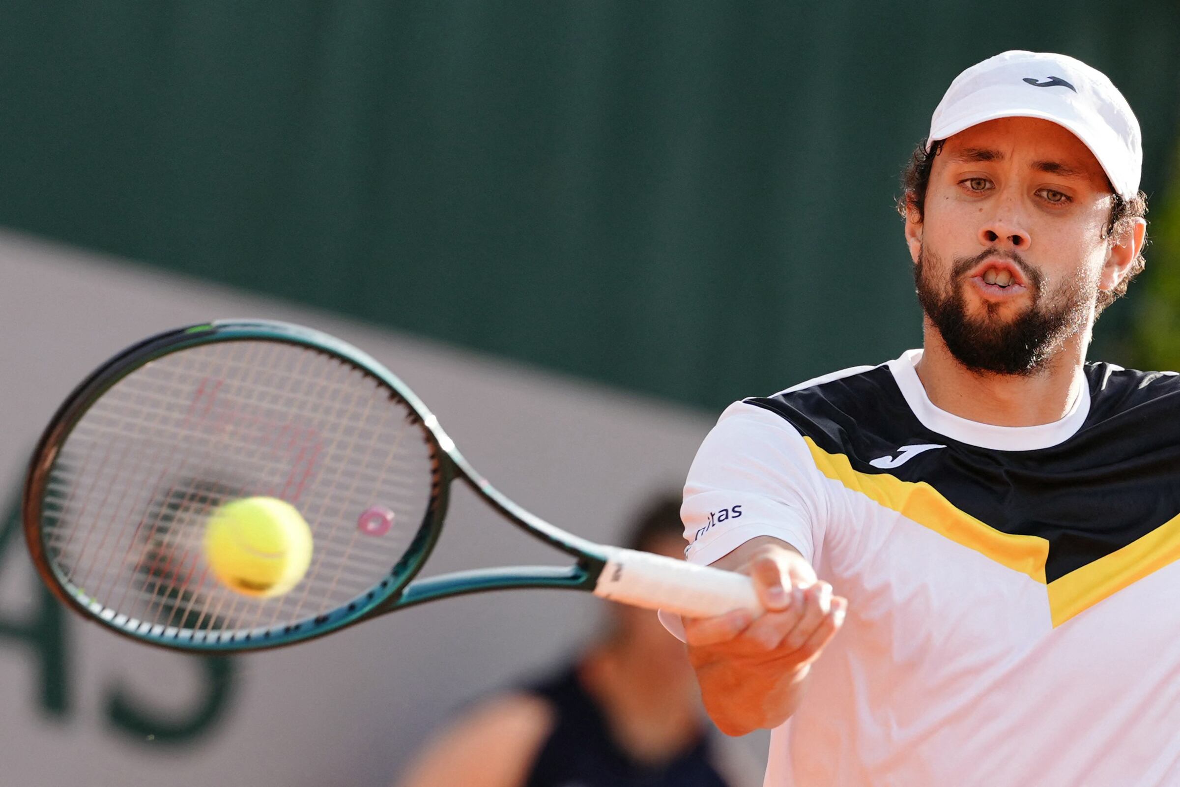 Colombia's Daniel Elahi Galan plays a forehand return to Italy's Lorenzo Musetti during their men's singles match on day two of The French Open tennis tournament at The Roland Garros Complex in Paris on May 27, 2024. (Photo by Dimitar DILKOFF / AFP)
