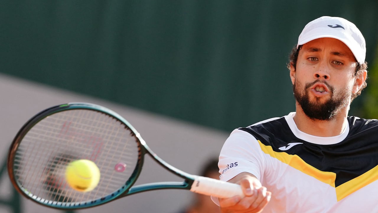 Colombia's Daniel Elahi Galan plays a forehand return to Italy's Lorenzo Musetti during their men's singles match on day two of The French Open tennis tournament at The Roland Garros Complex in Paris on May 27, 2024. (Photo by Dimitar DILKOFF / AFP)