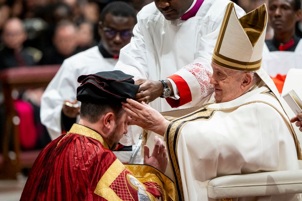 VATICAN CITY, VATICAN - 2024/12/07: Pope Francis places the Cardinal's hat on the head of the new Cardinal Mykola Bychok C.Ss.R. during the celebration of the Ordinary Public Consistory at St Peter's Basilica in the Vatican. (Photo by Stefano Costantino/SOPA Images/LightRocket via Getty Images)