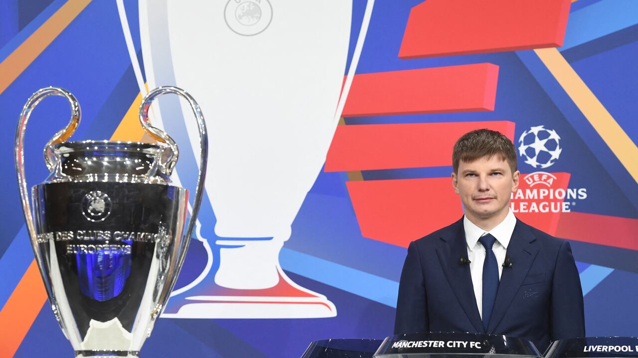 In this handout picture released by the UEFA, Russian former international forward Andrey Arshavin poses by the trophy during the Champions League round of 16 draw at the UEFA headquarters in Nyon, on December 13, 2021. The first legs are scheduled for 15/16/22/23 February, with the second legs on 8/9/15/16 March.
Richard JUILLIART / UEFA / AFP
