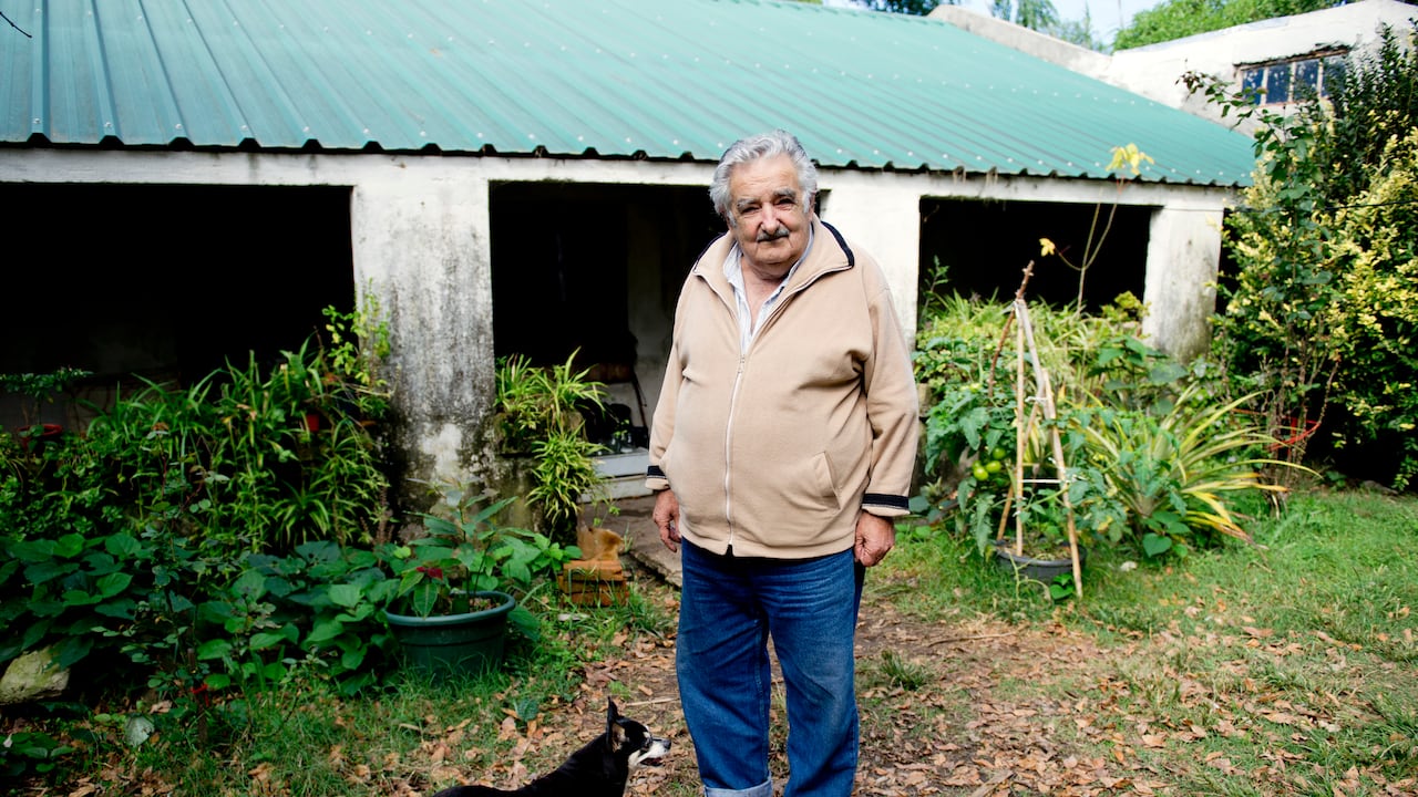 FILE - Uruguay's President Jose Mujica poses for a photo with his dog, Manuela, at his home on the outskirts of Montevideo, Uruguay, May 2, 2014. (AP Photo/Matilde Campodonico, File)