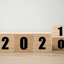 Hand flipping wooden blocks for change year 2020 to 2021 . New year and holiday concept.