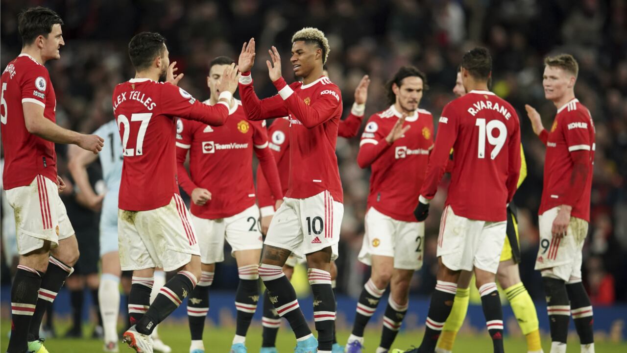 Manchester United's Marcus Rashford, center, celebrates with teammates after scoring his side's first goal during the English Premier League soccer match between Manchester United and West Ham at Old Trafford stadium in Manchester, England, Saturday, Jan. 22, 2022. (AP/Dave Thompson)