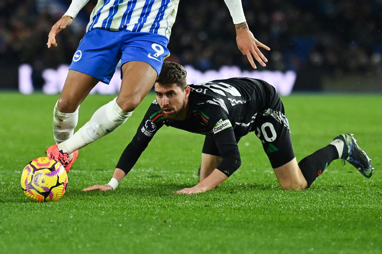 Arsenal's Italian midfielder #20 Jorginho (R) looks at the ball controled by Brighton's Brazilian striker #09 Joao Pedro during the English Premier League football match between Brighton and Hove Albion and Arsenal at the American Express Community Stadium in Brighton, southern England on January 4, 2025. (Photo by Glyn KIRK / AFP) / RESTRICTED TO EDITORIAL USE. No use with unauthorized audio, video, data, fixture lists, club/league logos or 'live' services. Online in-match use limited to 120 images. An additional 40 images may be used in extra time. No video emulation. Social media in-match use limited to 120 images. An additional 40 images may be used in extra time. No use in betting publications, games or single club/league/player publications. / ALTERNATIVE CROP