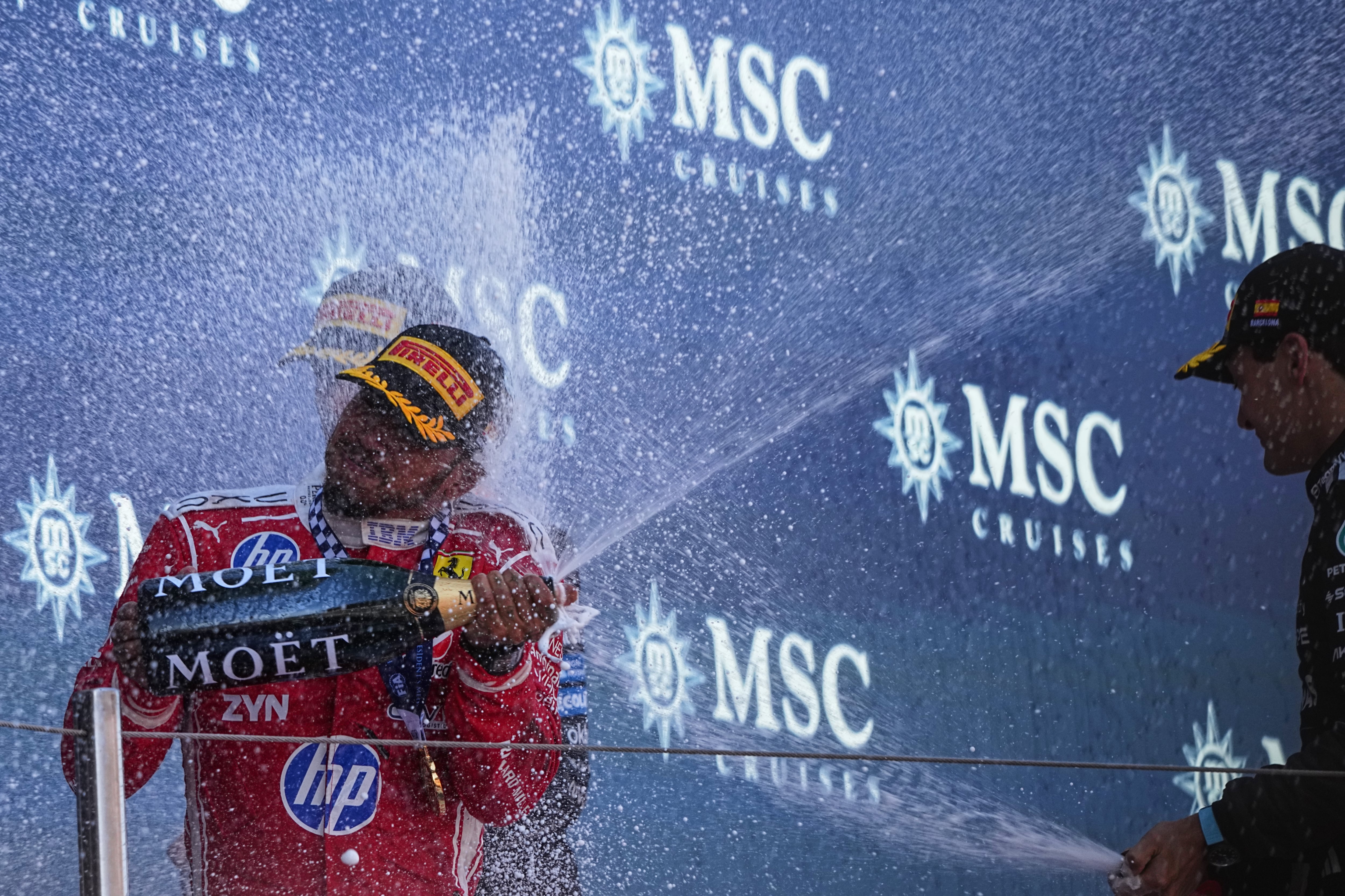 Ferrari driver Lewis Hamilton, left, of Britain celebrates after wining the Spain F1 Grand Prix race at the Barcelona Catalunya racetrack in Montmelo, near Barcelona, Spain, Sunday, June 14, 2026. (AP Photo/Fatima Shbair)