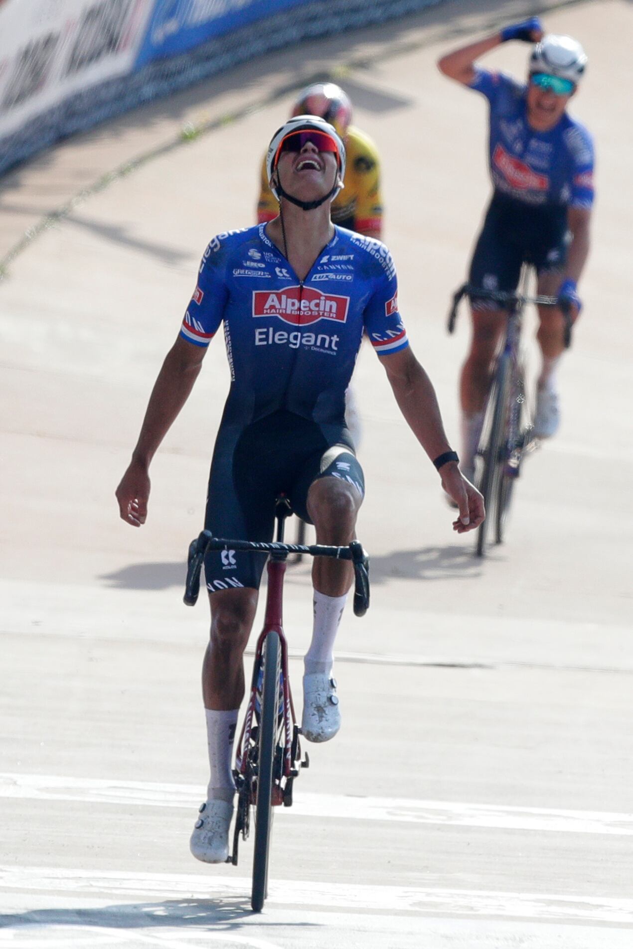 Mathieu Van der Poel, of the Netherlands, celebrates as he crosses the finish line to win the men's Paris-Roubaix cycling race, at the velodrome in Roubaix, northern France, Sunday, April. 9, 2023. (AP Photo/Michel Spingler)